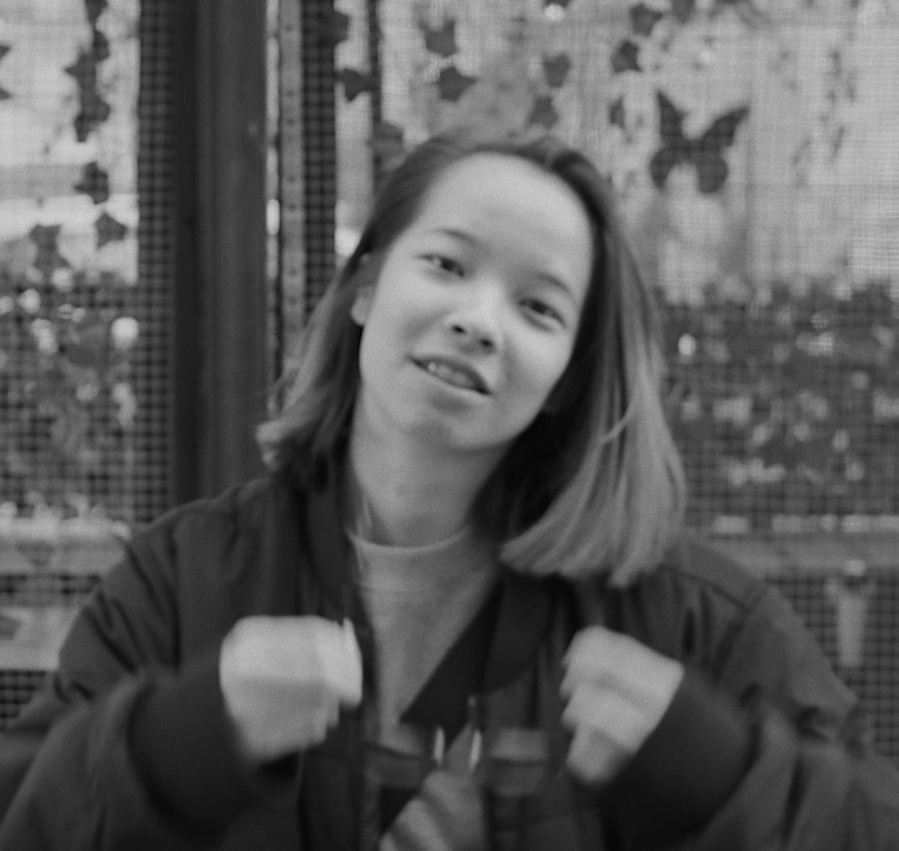 Black and white photo of a smiling young woman with shoulder-length hair.