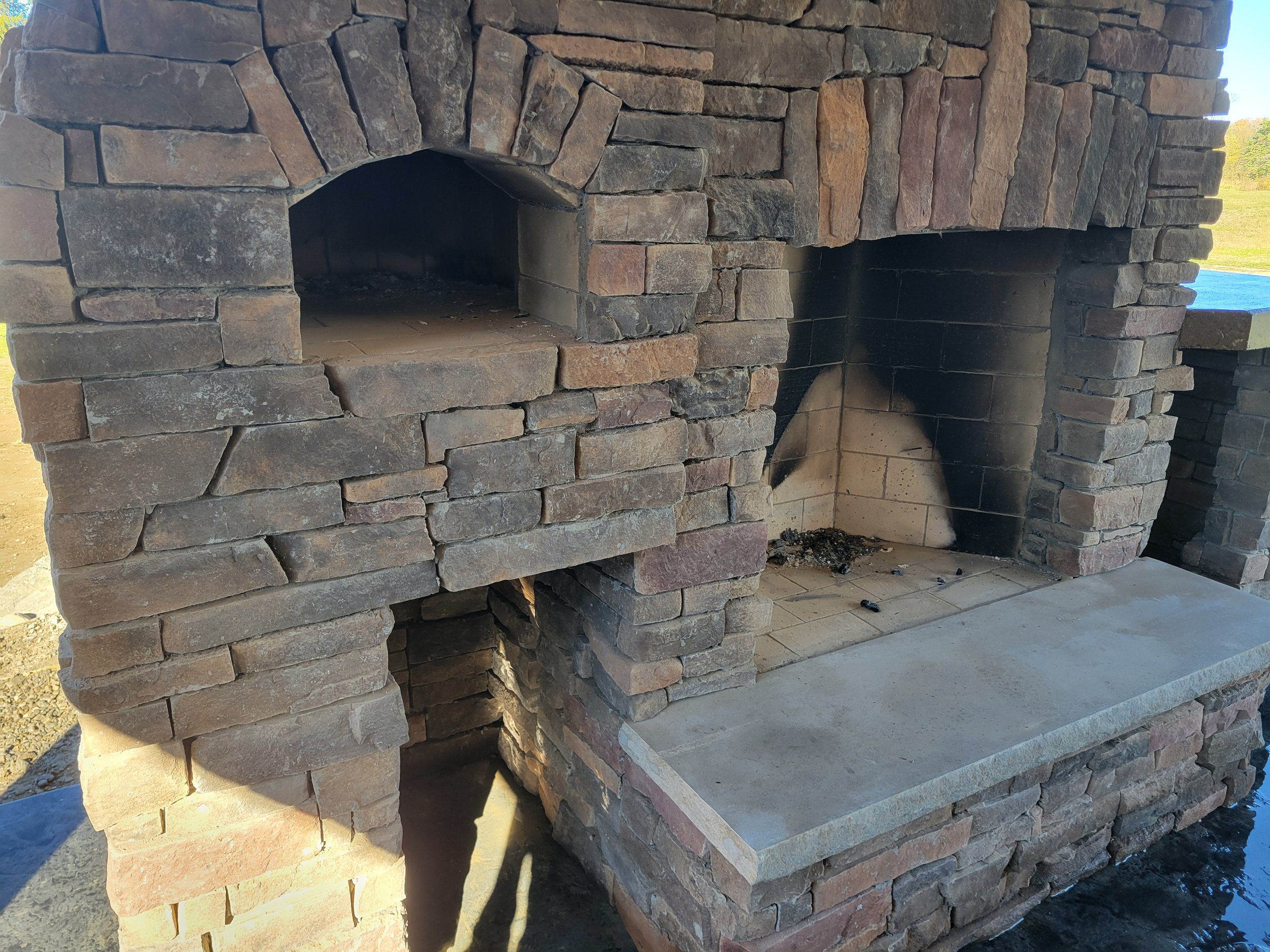 Close up of outdoor fireplace and pizza oven in Collins, NY.