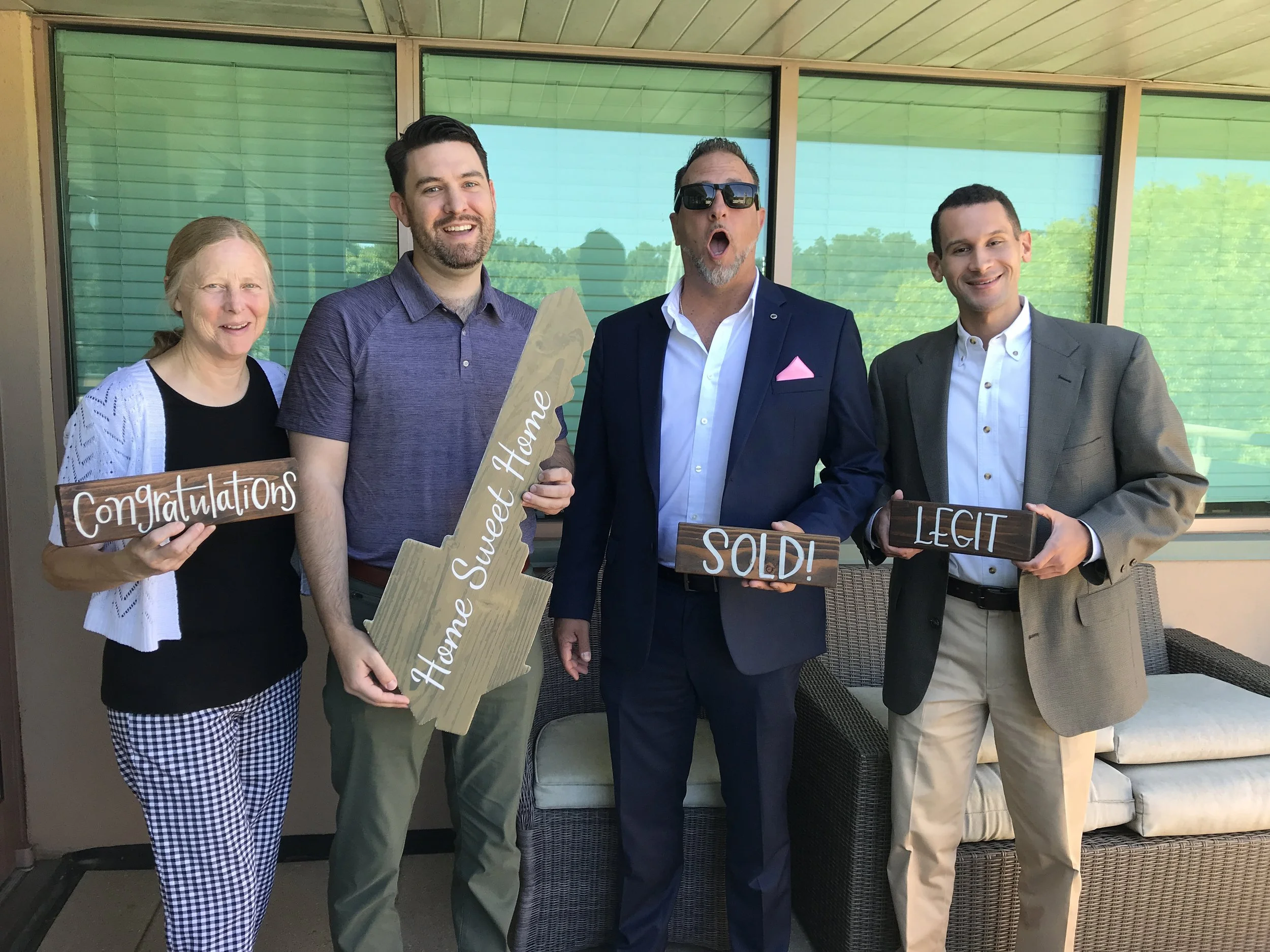 Clients celebrating closing day with their real estate agent Cameran Jaques in Atlanta