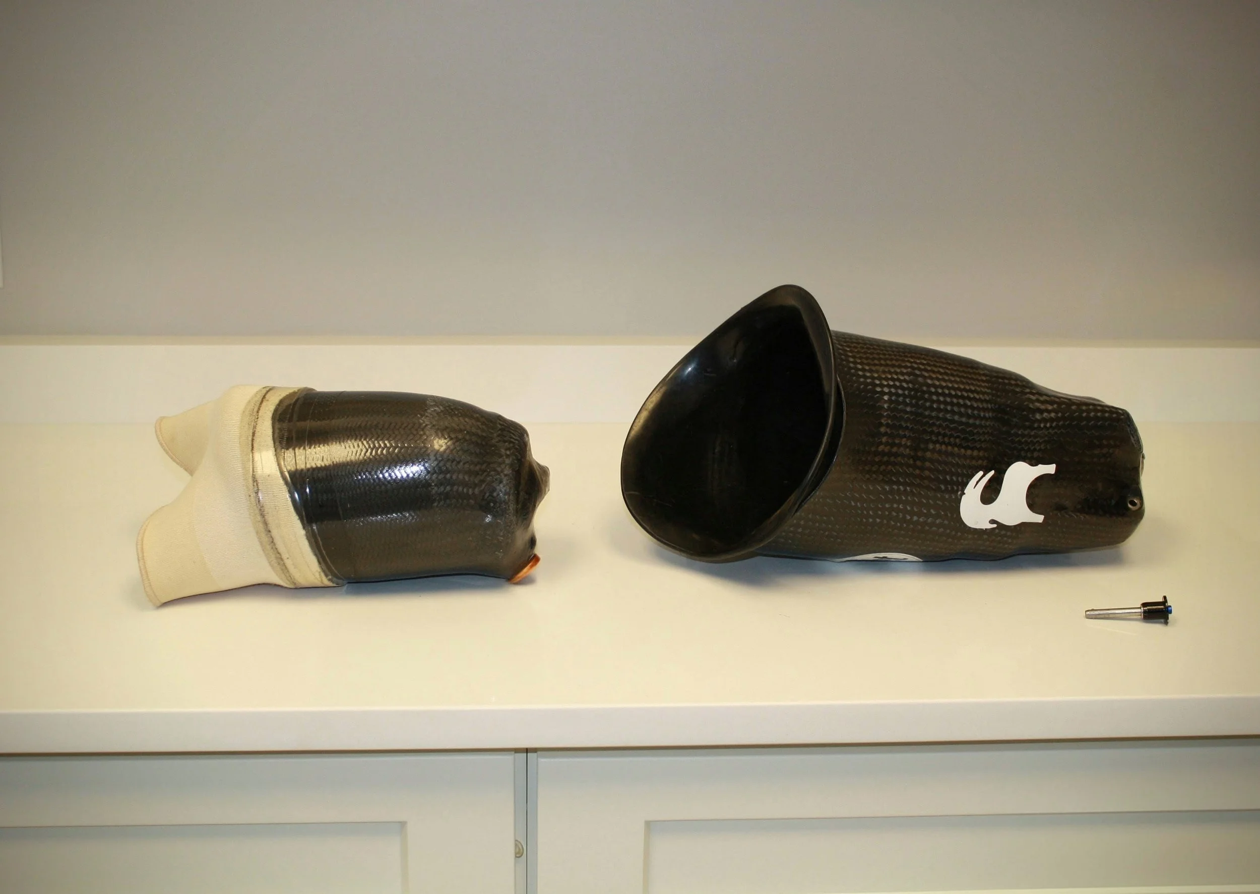 A double wall above knee suction socket with ischial containment made of carbon fiber and flexible plastic.