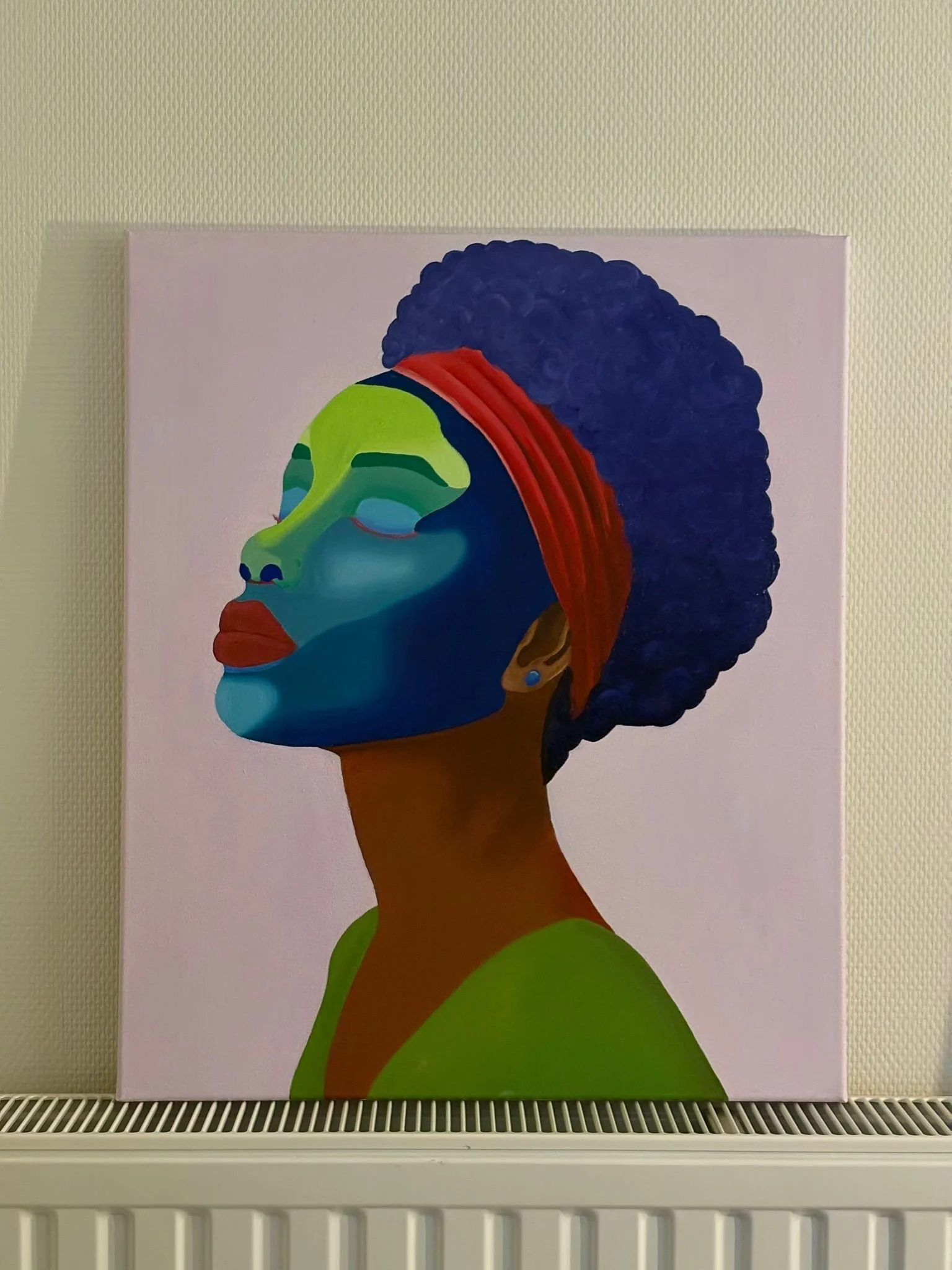 Portrait of a woman with colorful face paint and a curly wig against a light background.