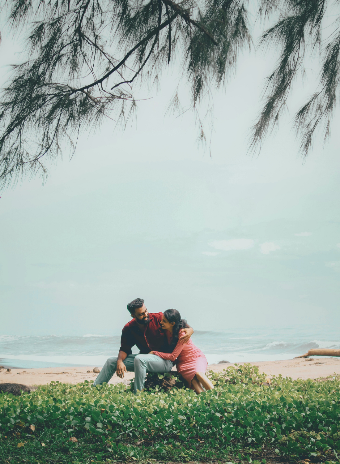 Couple sitting together on the beach, representing couples therapy and relationship support
