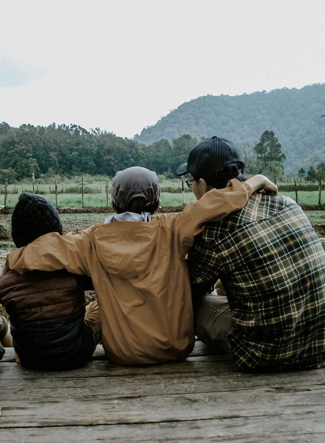 Parent with children outdoors, symbolizing family therapy and strengthening family relationships