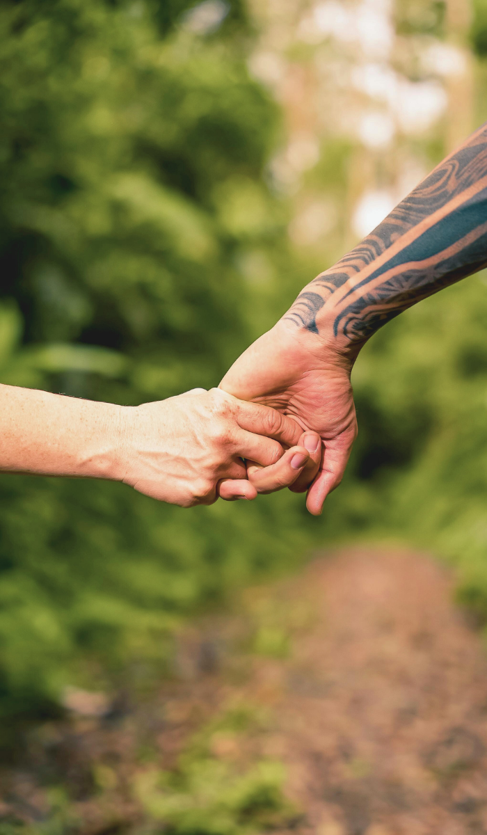 Couple holding hands outdoors, LGBTQ affirming couples therapist in Florida and California