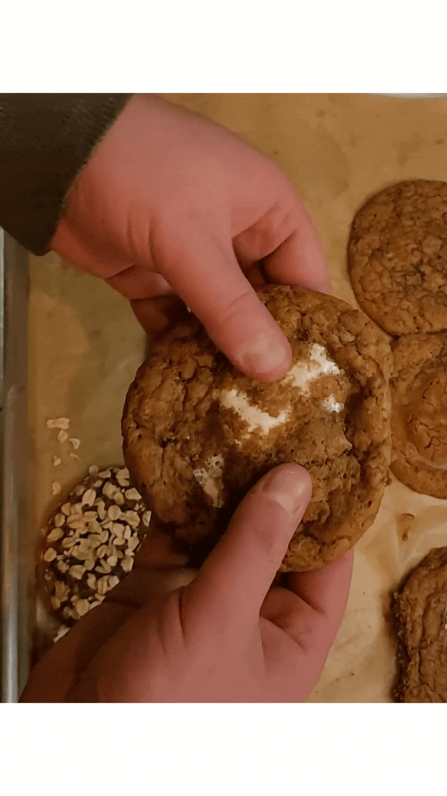 A GIF of a marshmallow-filled cookie being pulled apart slowly and sensually.