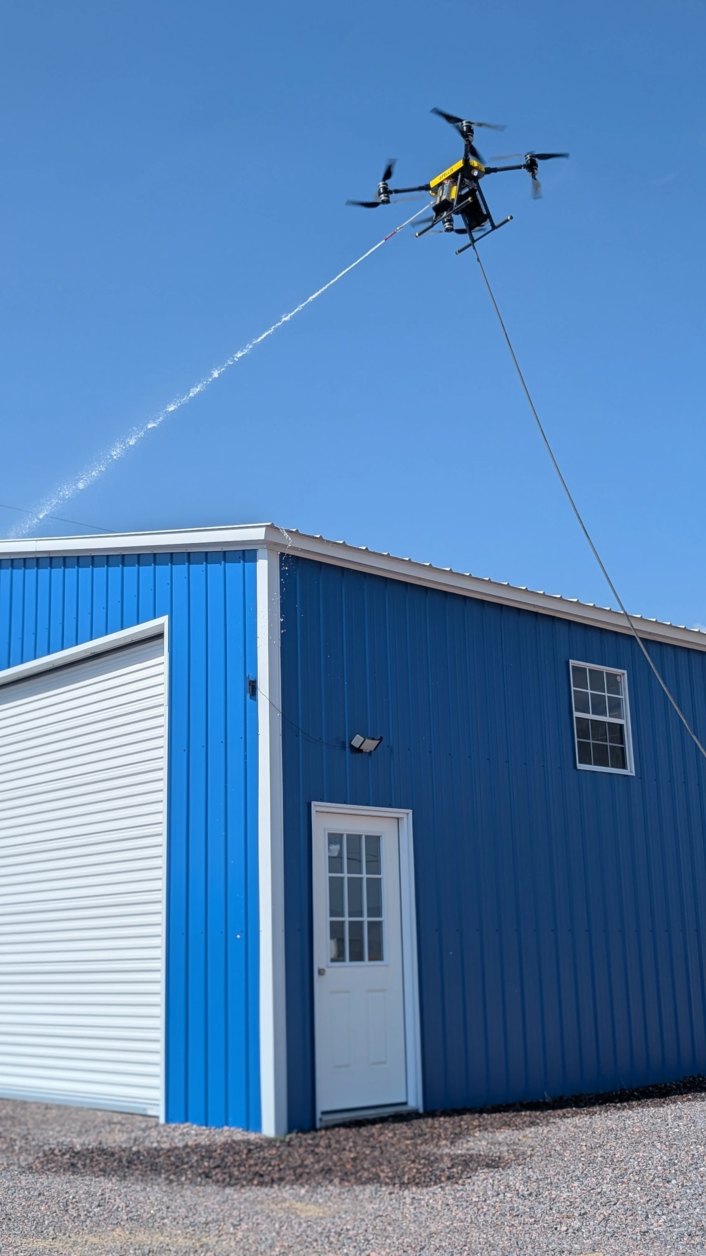 Drone cleaning blue building