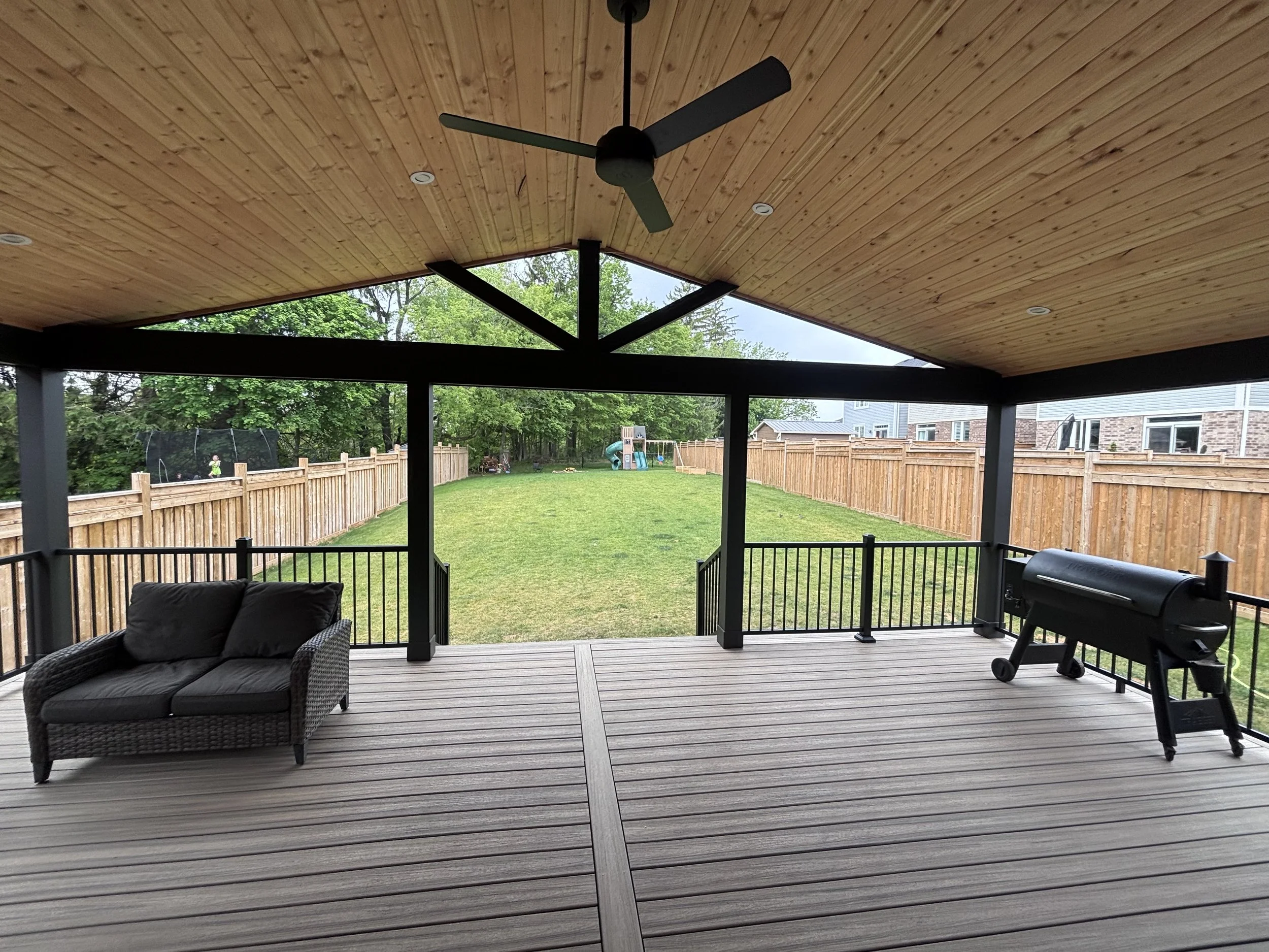 completed covered deck in Port Perry with Trex decking and douglas fir tongue and groove ceiling 