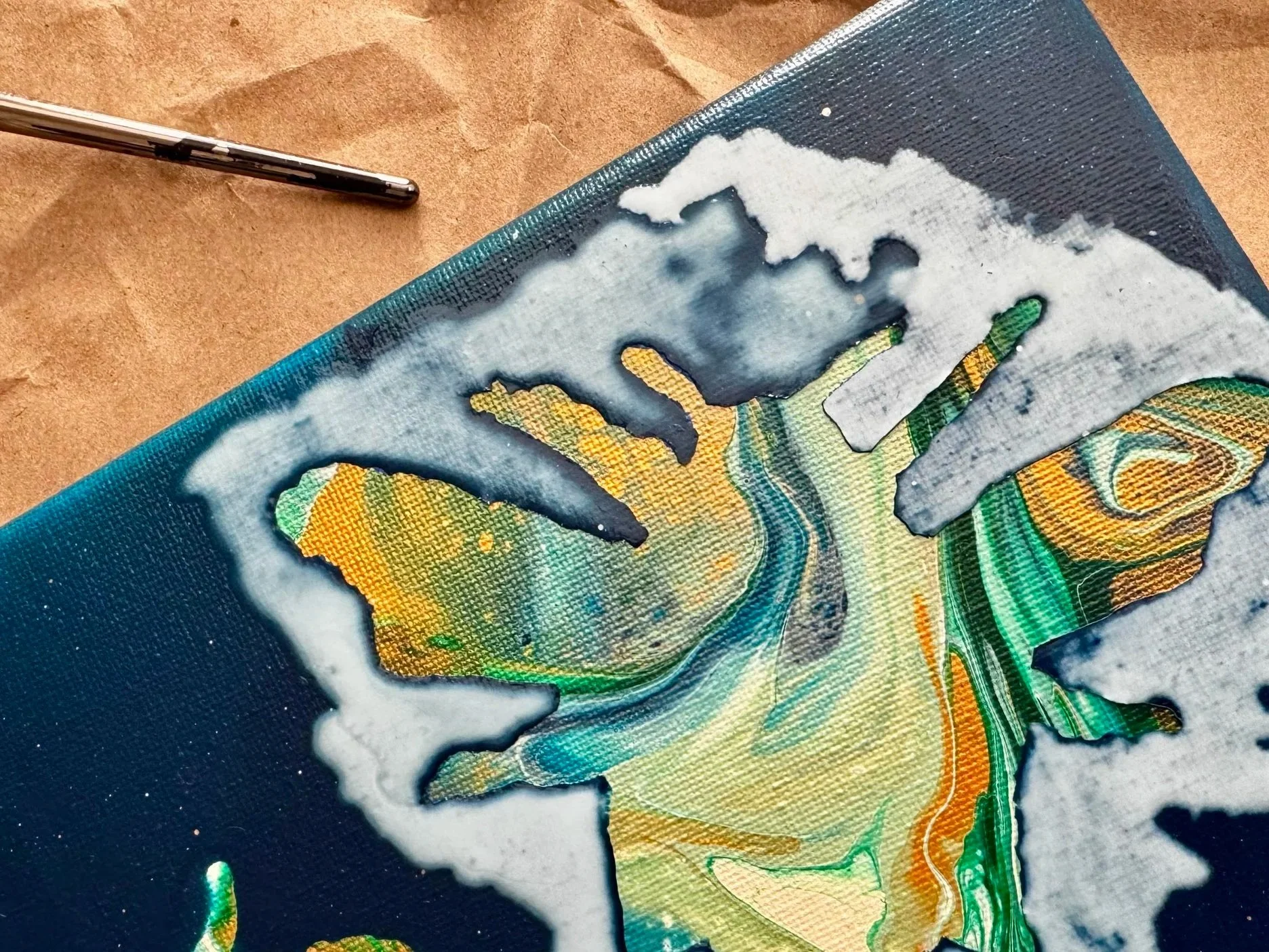 Painting of a bumble bee with green, gold, cream, and blue paint.