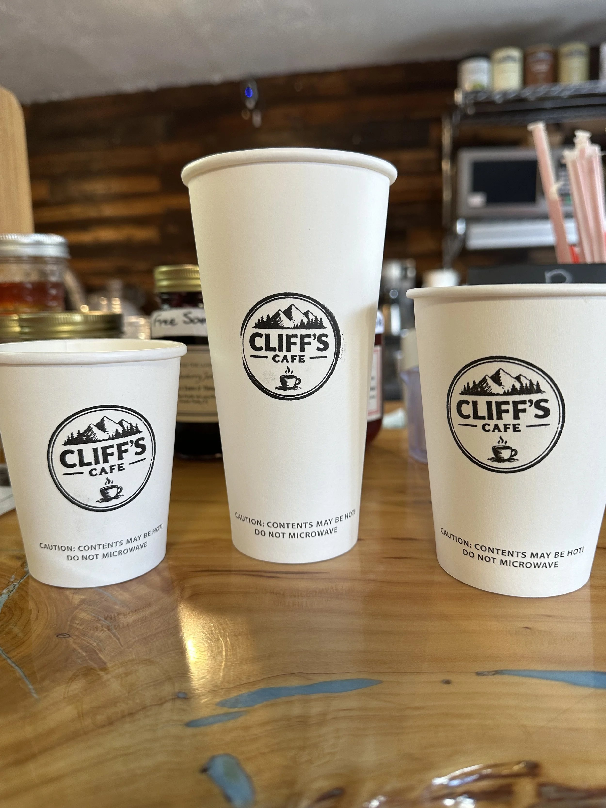 photo of 3 different sized coffee cups with the Cliff's logo
