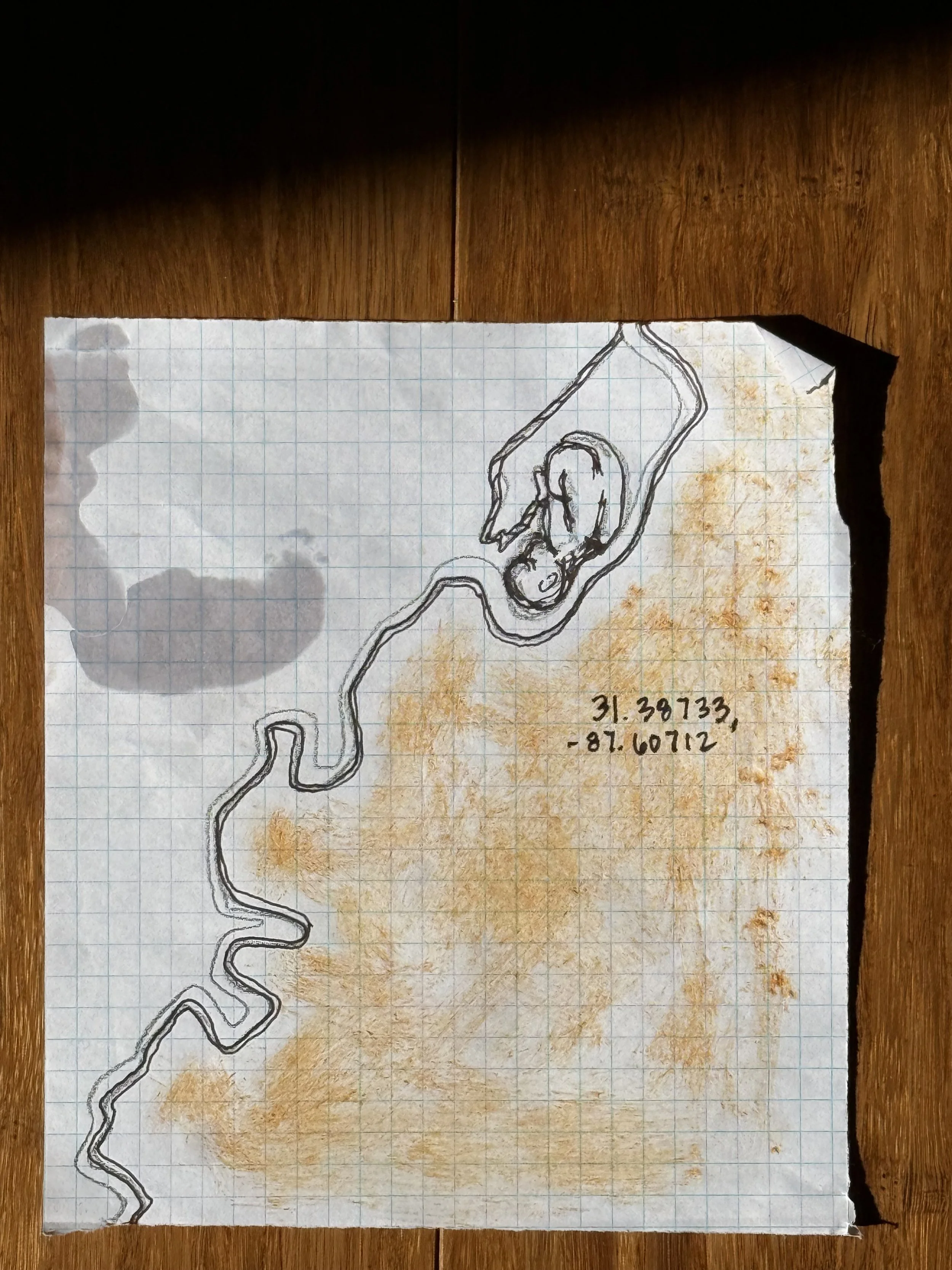 Hand-drawn map on graph paper with handwritten coordinates 31.39733, -87.60712 and a sketch of a winding road or path and a person.