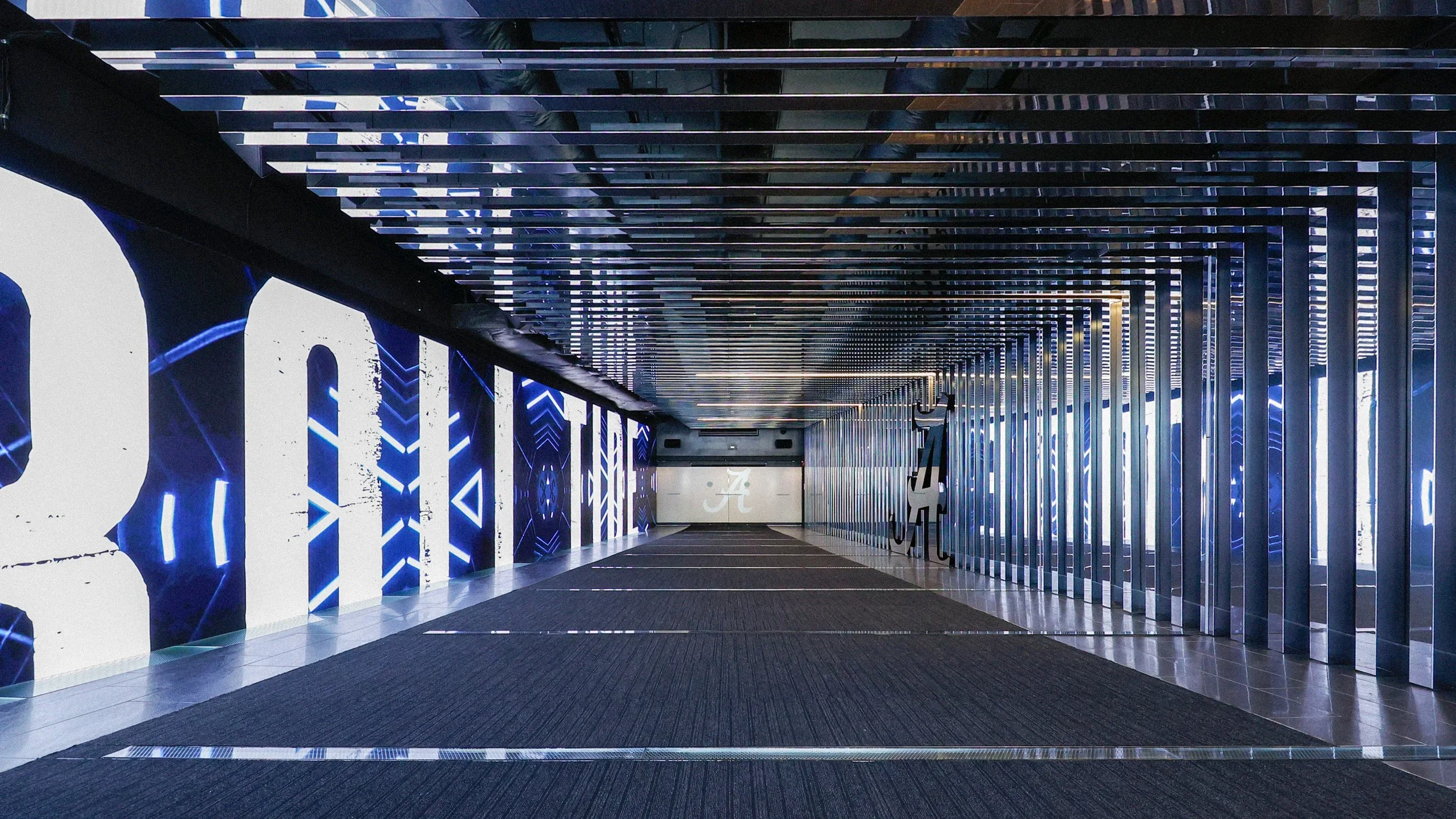 Alabama Sports Center player tunnel with LED video wall displays and mirrored ceiling