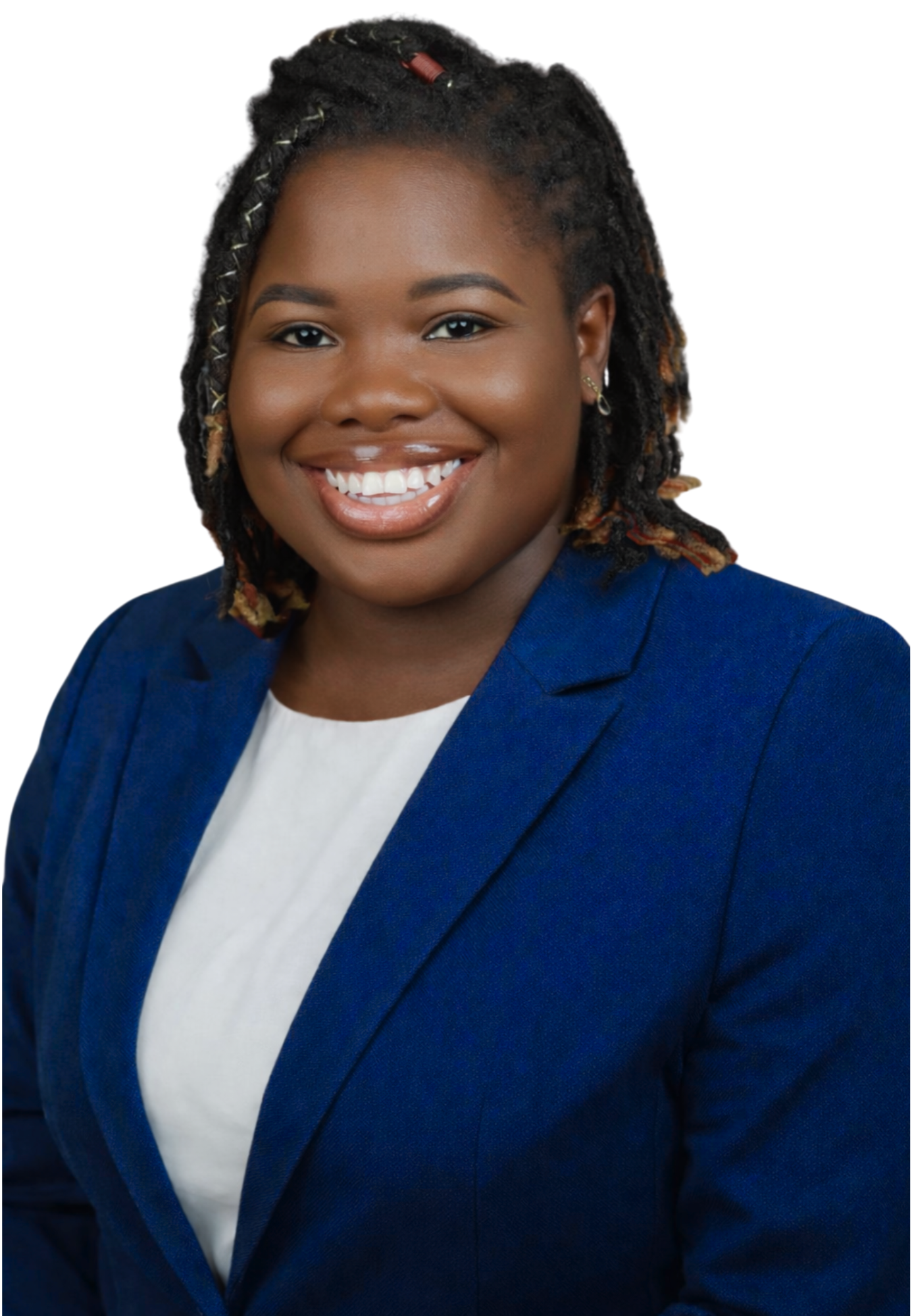 A woman with dark skin and shoulder-length styled dreadlocks, wearing a blue blazer and white top, smiling at the camera.
