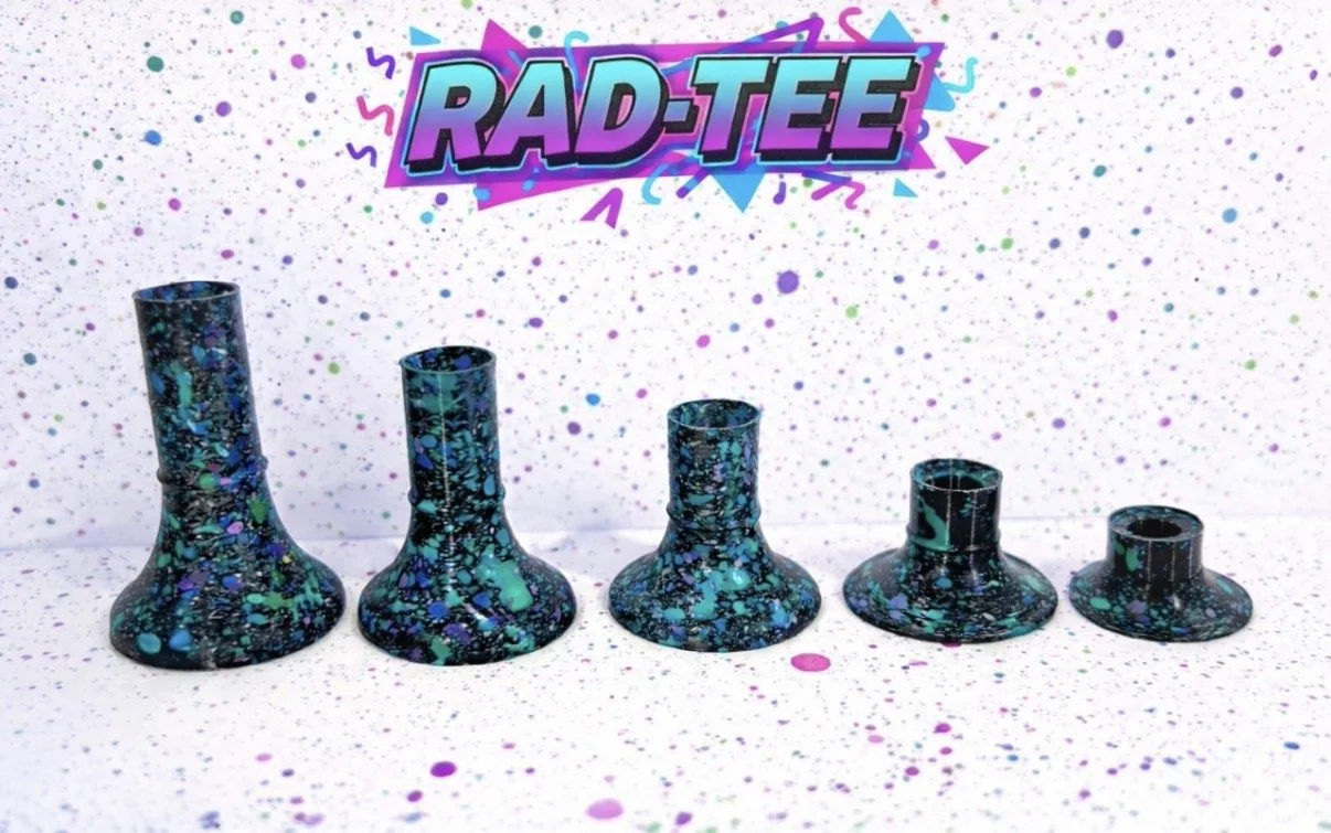 A set of five black vases with colorful splatter paint designs, arranged from largest to smallest, with a vibrant "RAD-TEE" logo above them against a white background with colorful paint splatters.