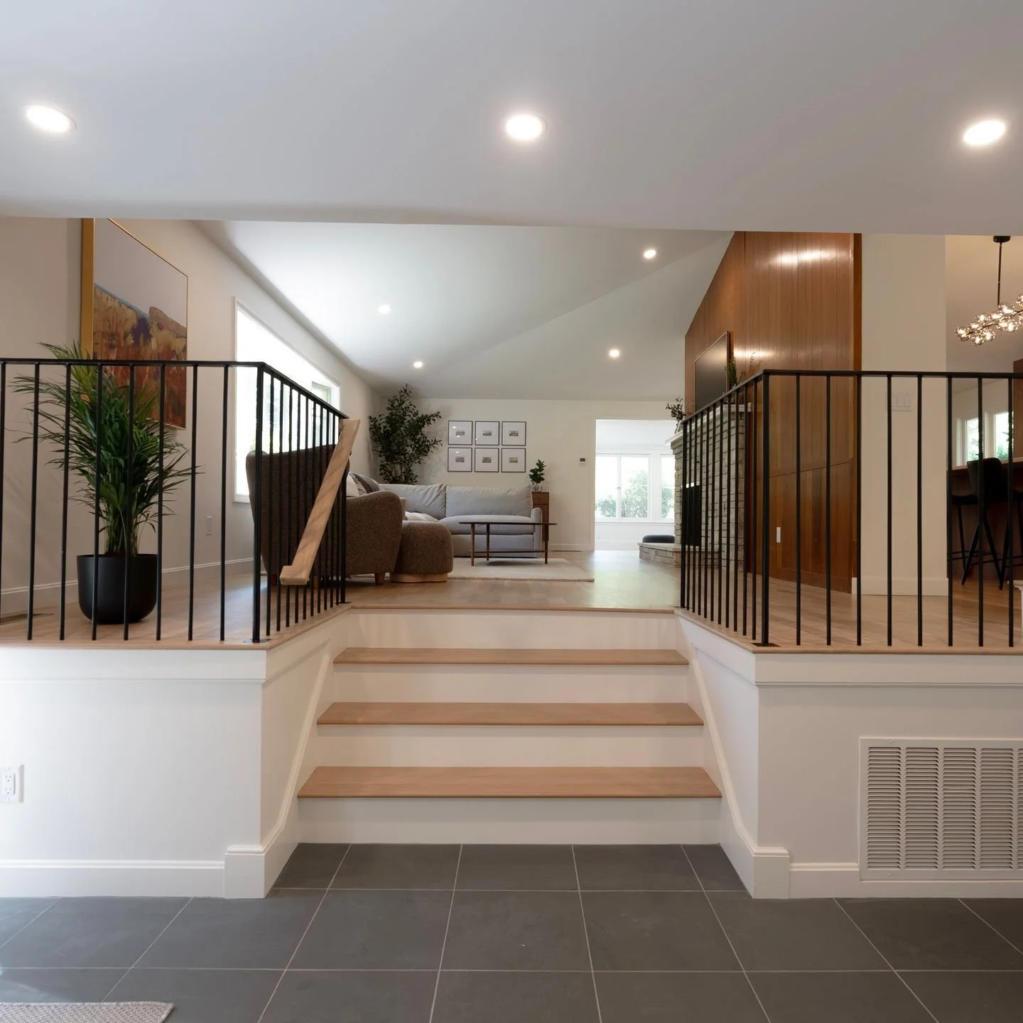 When updating a split-level home, details matter. Pairing modern metal railings with warm wood tones helped open up this entryway while keeping it welcoming, functional for everyday living, with a nod to the mid-century aesthetic throughout!

Builder