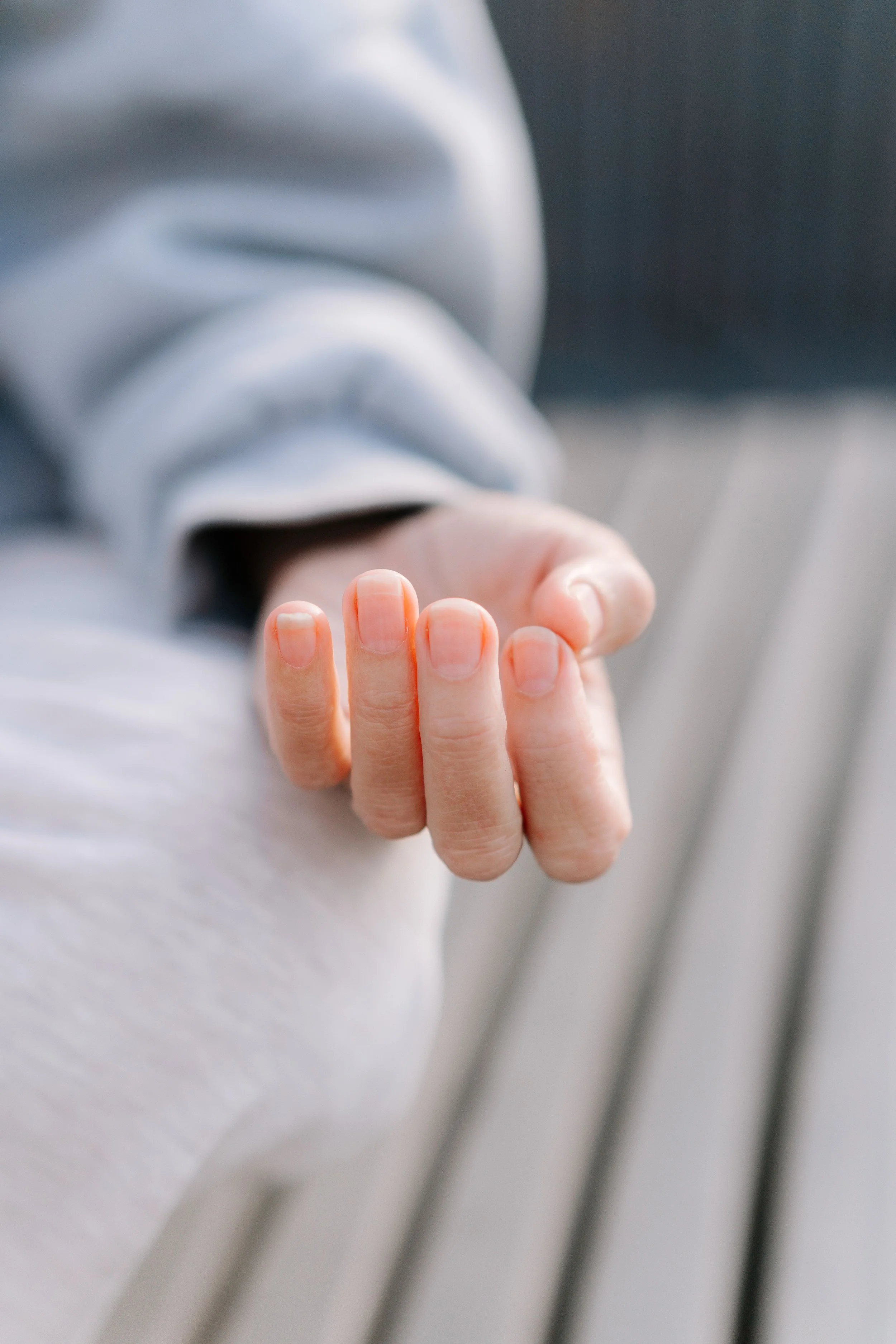 Open, relaxed hand resting palm-up in soft light, representing the release from white-knuckling that comes with burnout therapy at Healthy Mind, Healthy Heart
