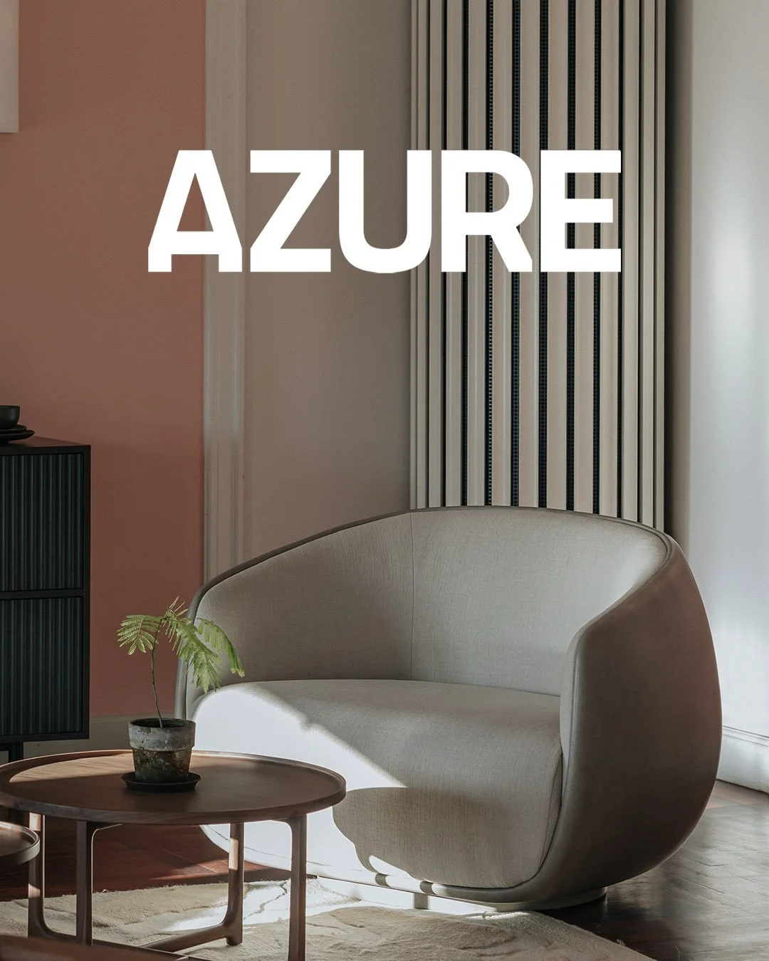 Modern living room with a beige curved armchair, a small wooden side table with a potted plant, a black cabinet, and decorative wall panels, with the word 'AZURE' in large white letters over the image.