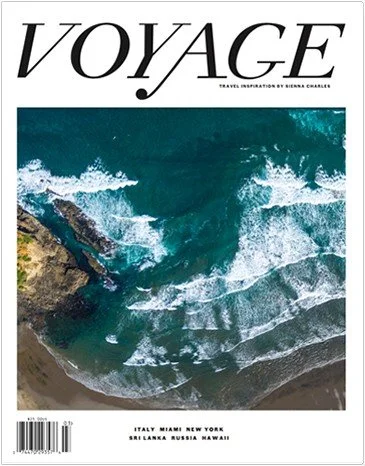 Magazine cover titled 'VOYAGE' featuring an aerial view of ocean waves crashing on a rocky shoreline.