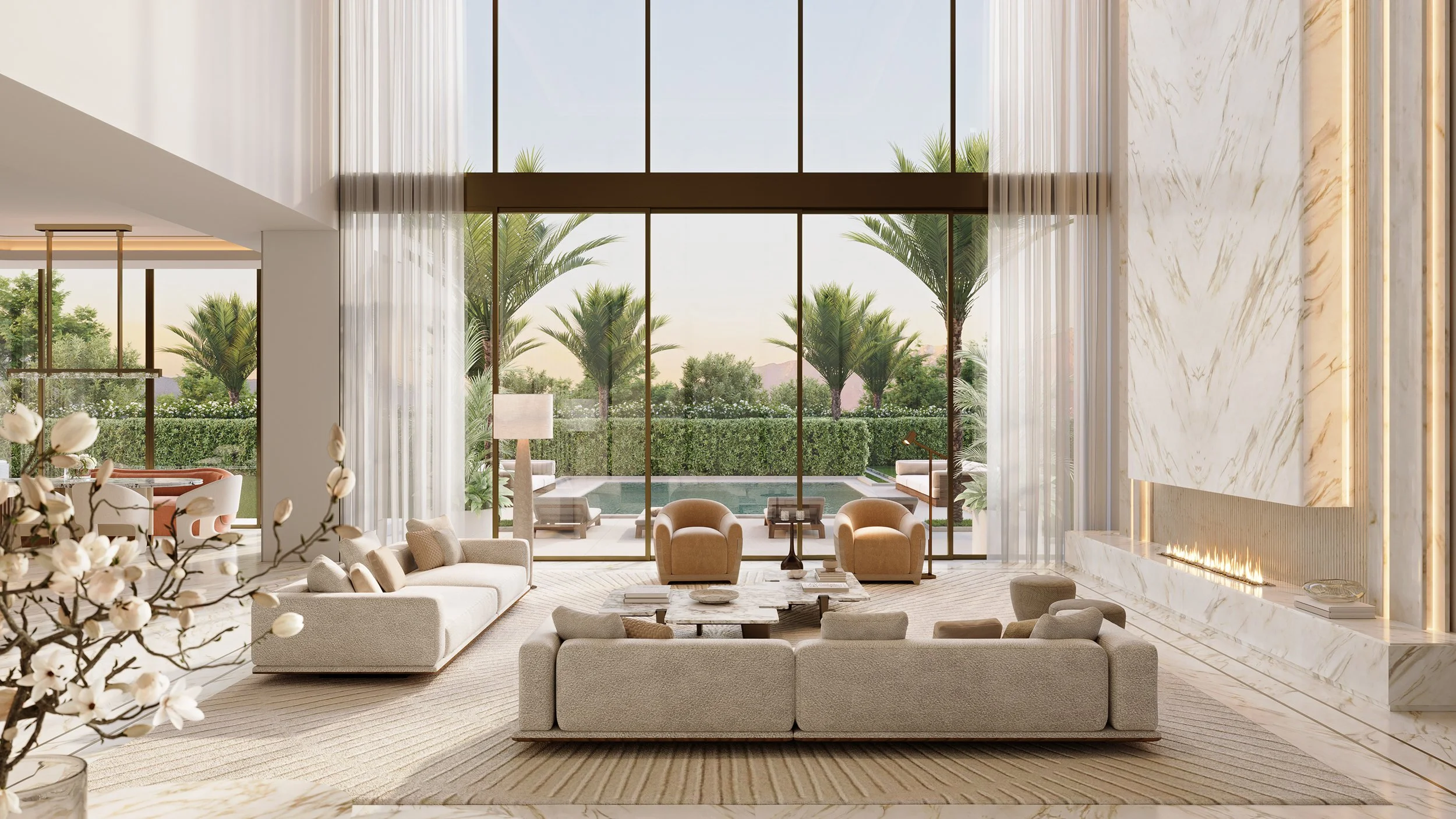 Luxurious living room with large glass windows showing outdoor patio with pool and palm trees, modern white furniture, and a marble fireplace.