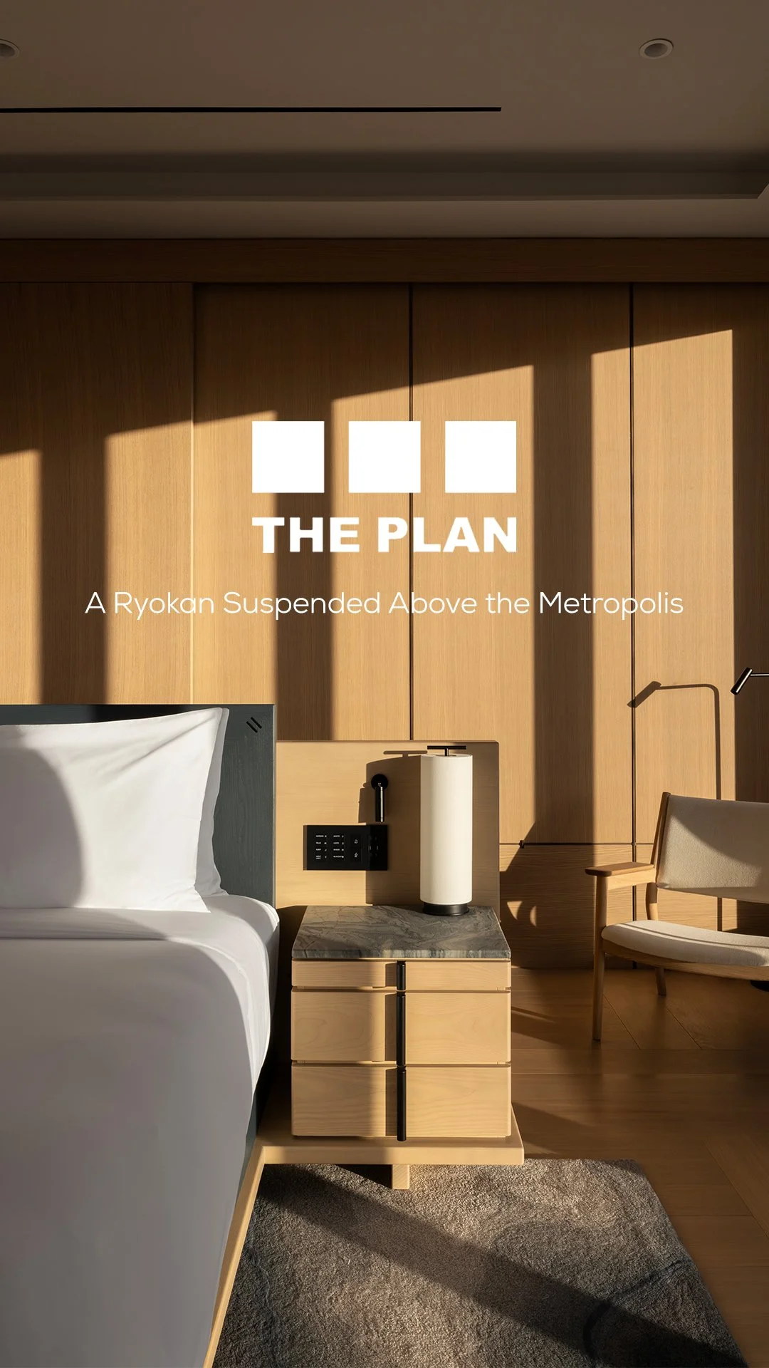 A hotel room interior with a bed, a bedside table with a paper towel holder, lamp, and a cozy armchair with wooden arms, all set against a wooden wall with sunlight casting shadows.