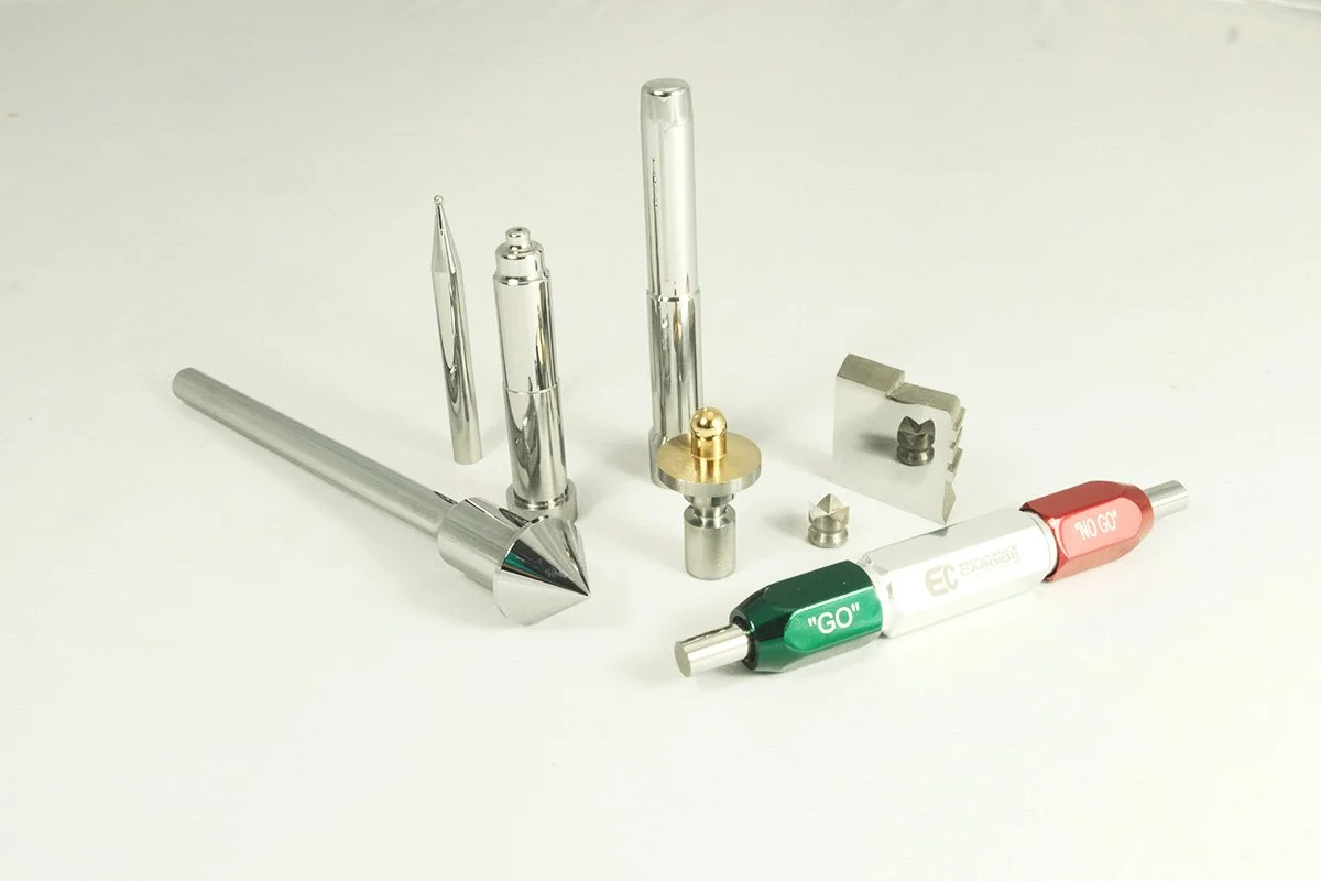 precision carbide tooling Collection of metal vape pen parts and accessories on a white background.