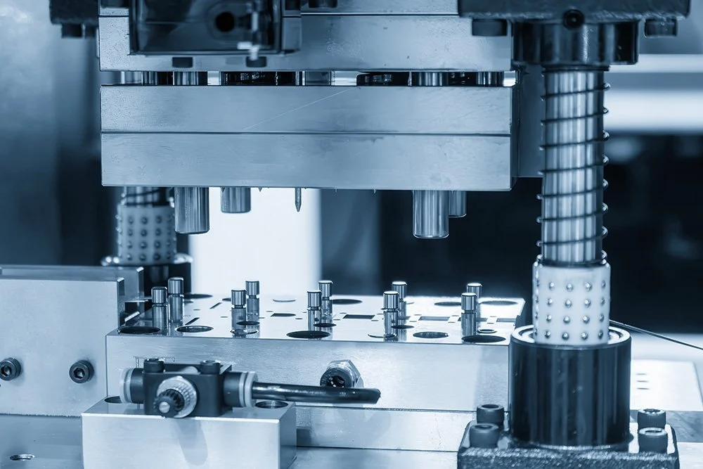 custom carbide tooling-Close-up of a precision manufacturing or assembly machine with metal components and mechanical parts.