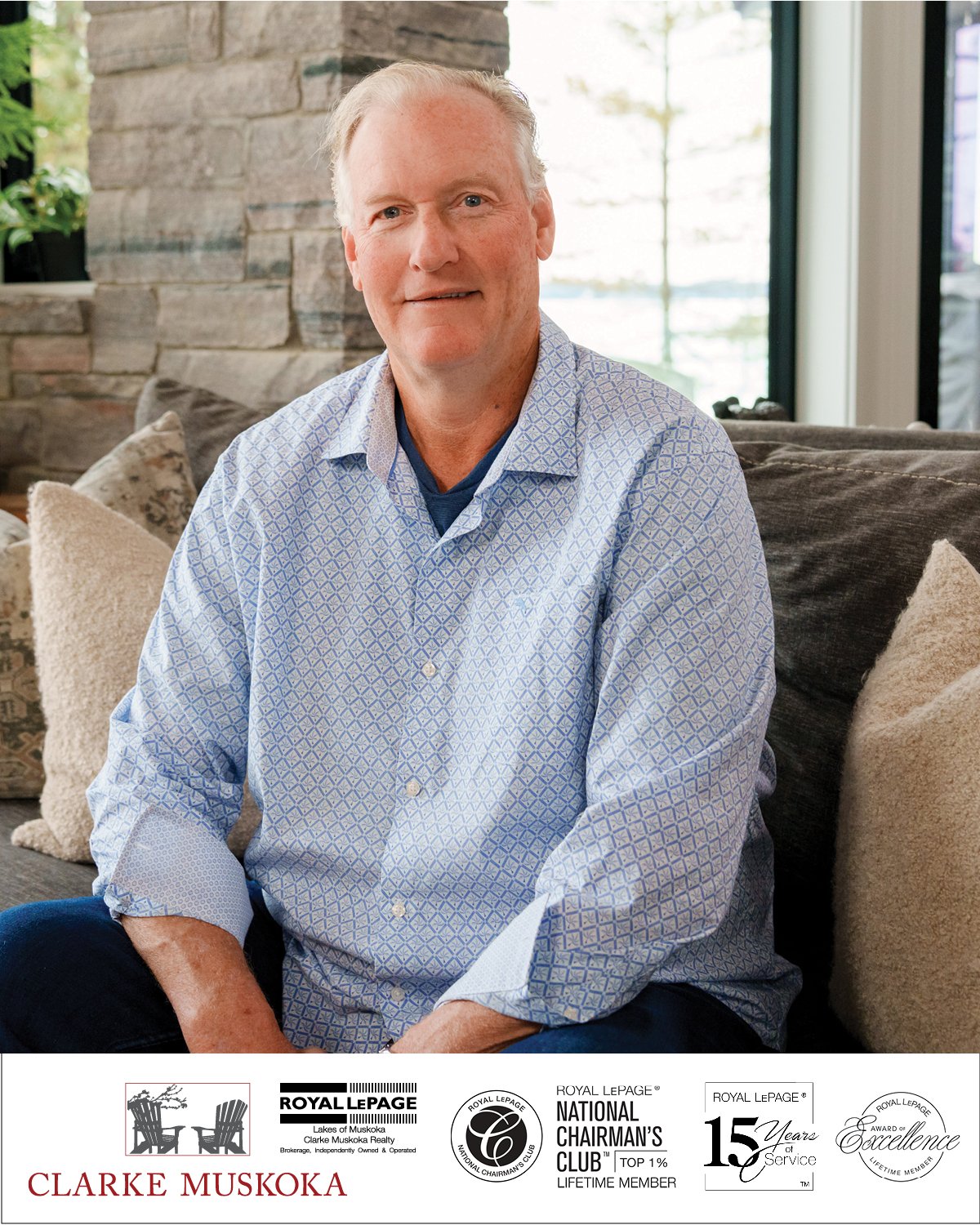 Bob Clarke, founder of Clarke Muskoka Realty, seated in a Muskoka cottage interior — Royal LePage National Chairman's Club Top 1% Lifetime Member
