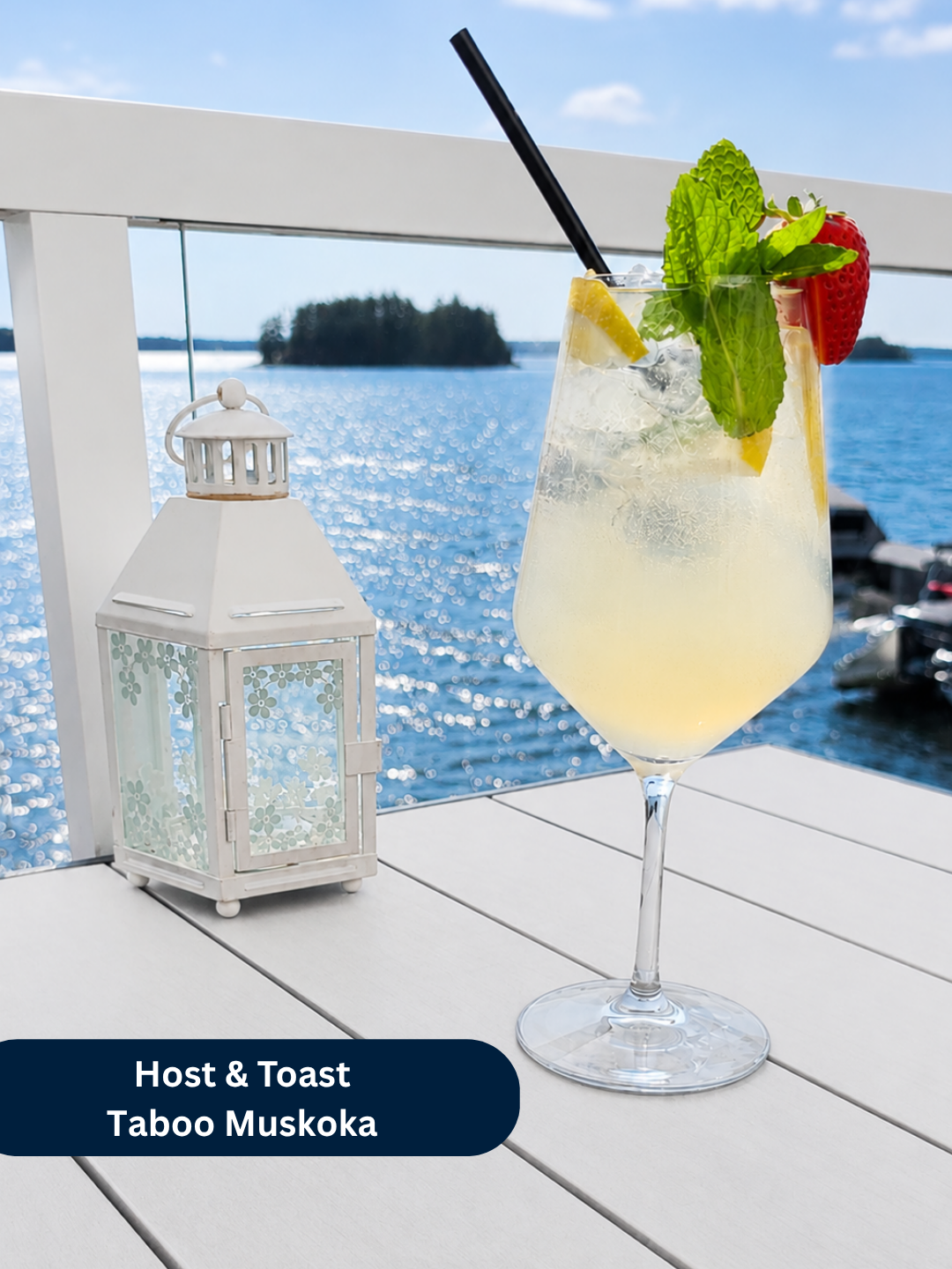 White Sangria cocktail garnished with mint, lemon and strawberry on a lakeside table at The Boathouse at Taboo on Lake Muskoka