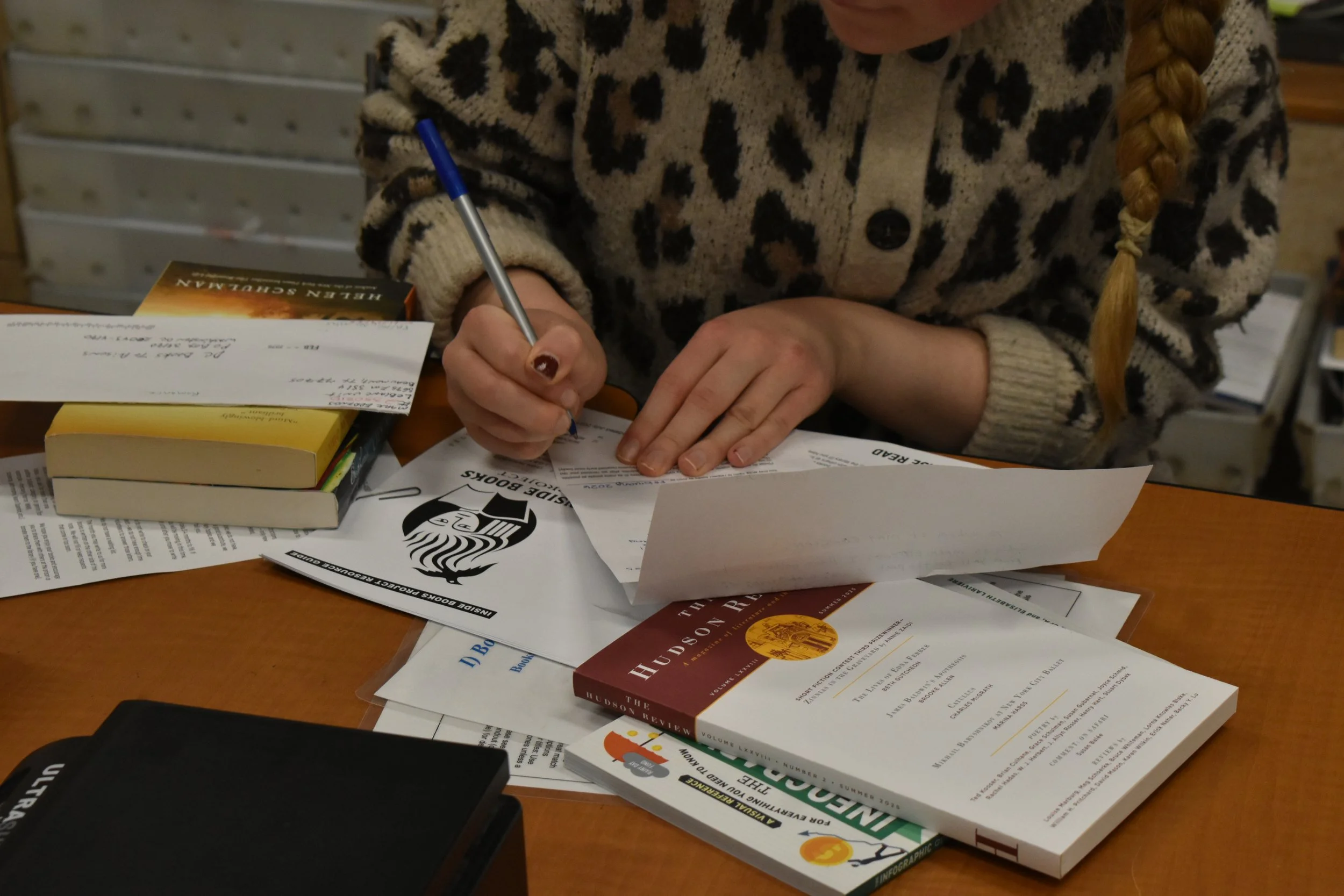 Volunteer writing a note to a to send along with some books.