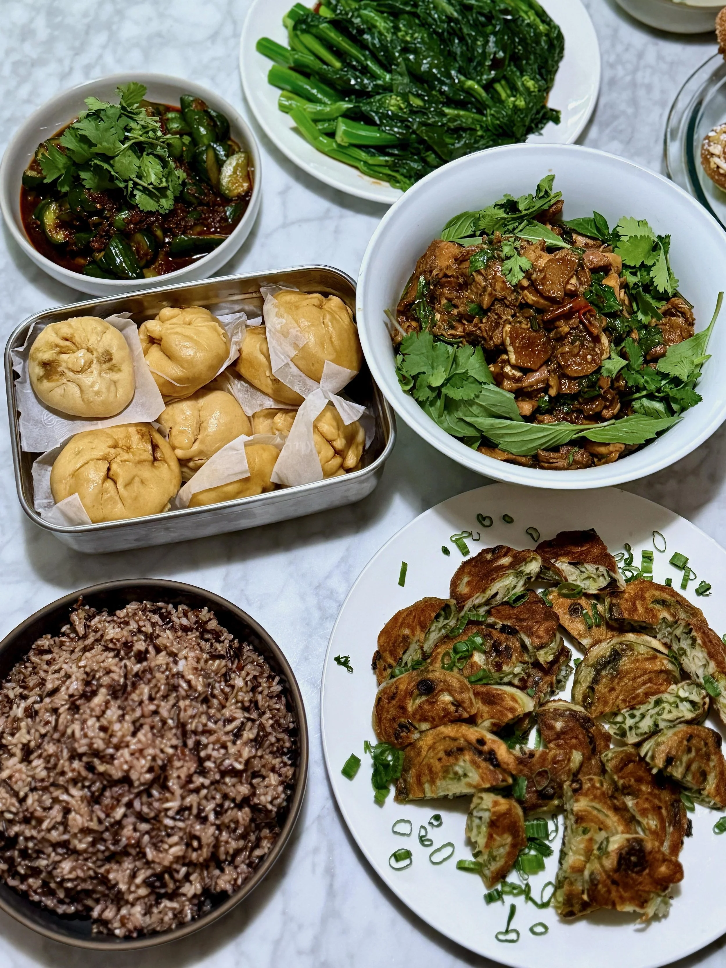 Scallion pancakes, wild rice blend, three cup chicken, chinese broccoli, pork bao, and spicy smacked cucumber salad - home cooking and food photography by Matt Kollander
