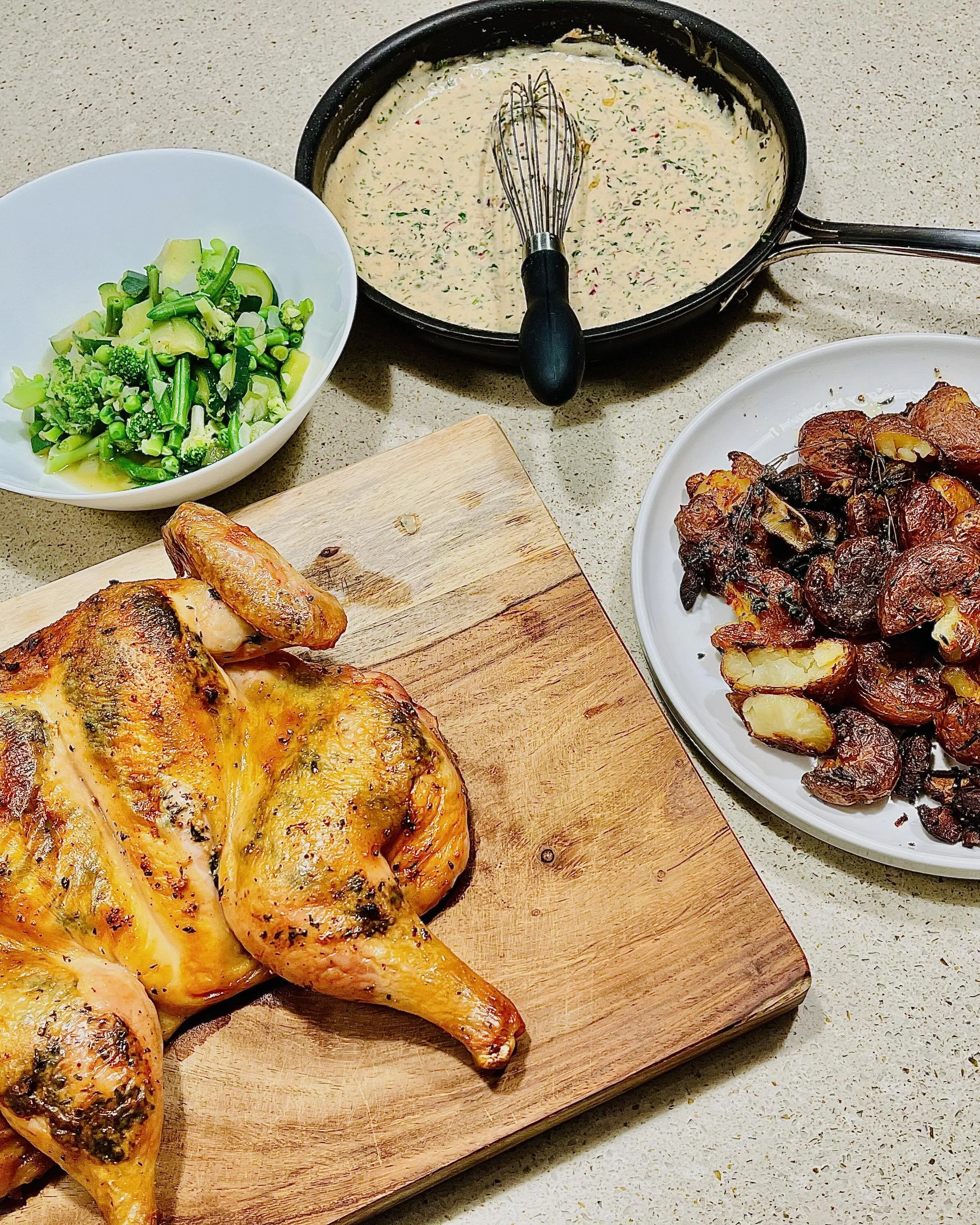 Herb spatchcock roast chicken, roast red potatoes, greens, and mustard lemon cream sauce - home cooking and food photography by Matt Kollander