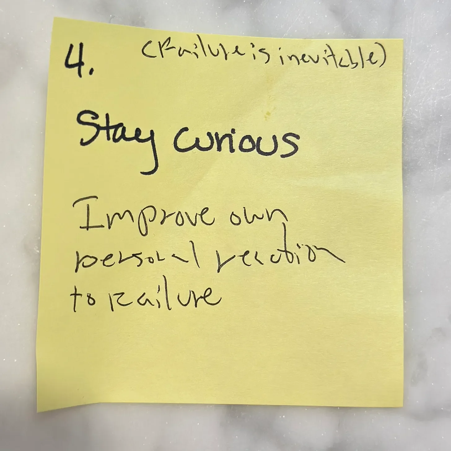 sticky note that says failure is inevitable, stay curious, improve own personal reaction to failure.