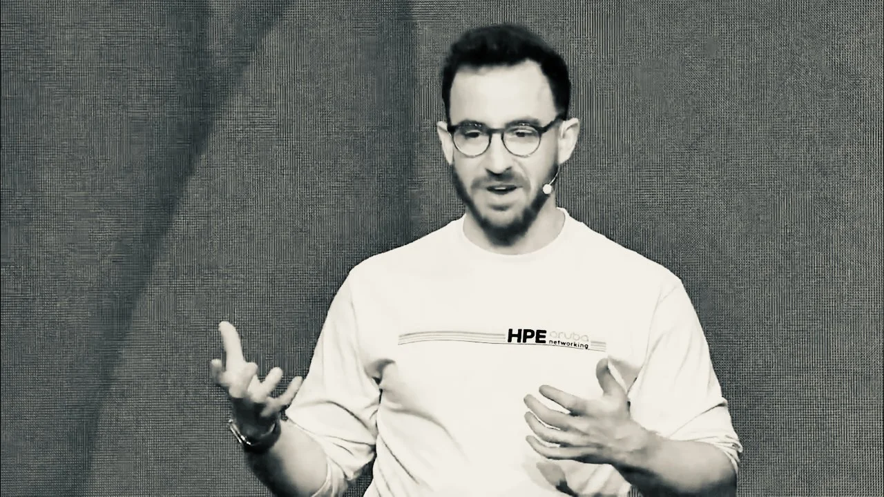 Matt Kollander speaking to the audience at a technology keynote