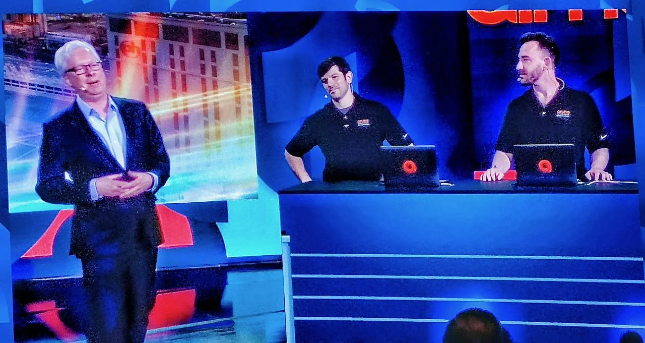 Matt Kollander presenting alongside a colleague during a conference keynote