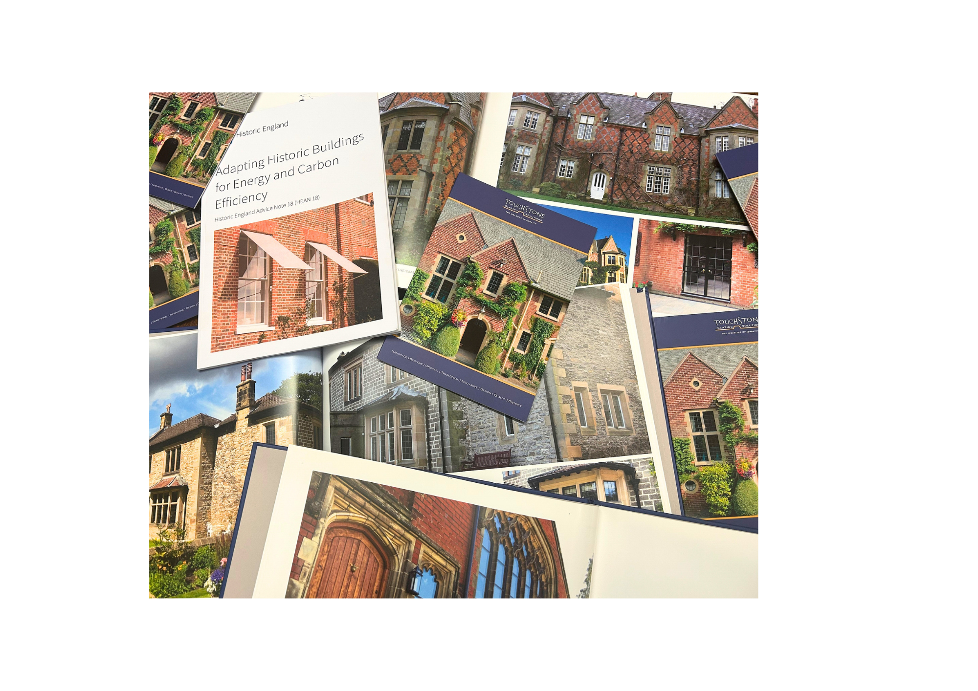 Collection of brochures and booklets about historic English buildings, showing photographs of various traditional brick and stone houses and architecture.