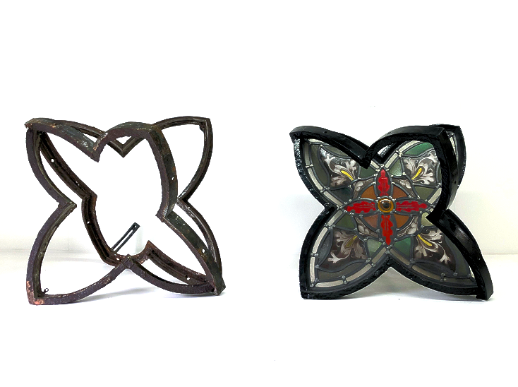 Two butterfly-shaped metal and glass sculptures, one with a black metal frame and the other with decorative glass filling.