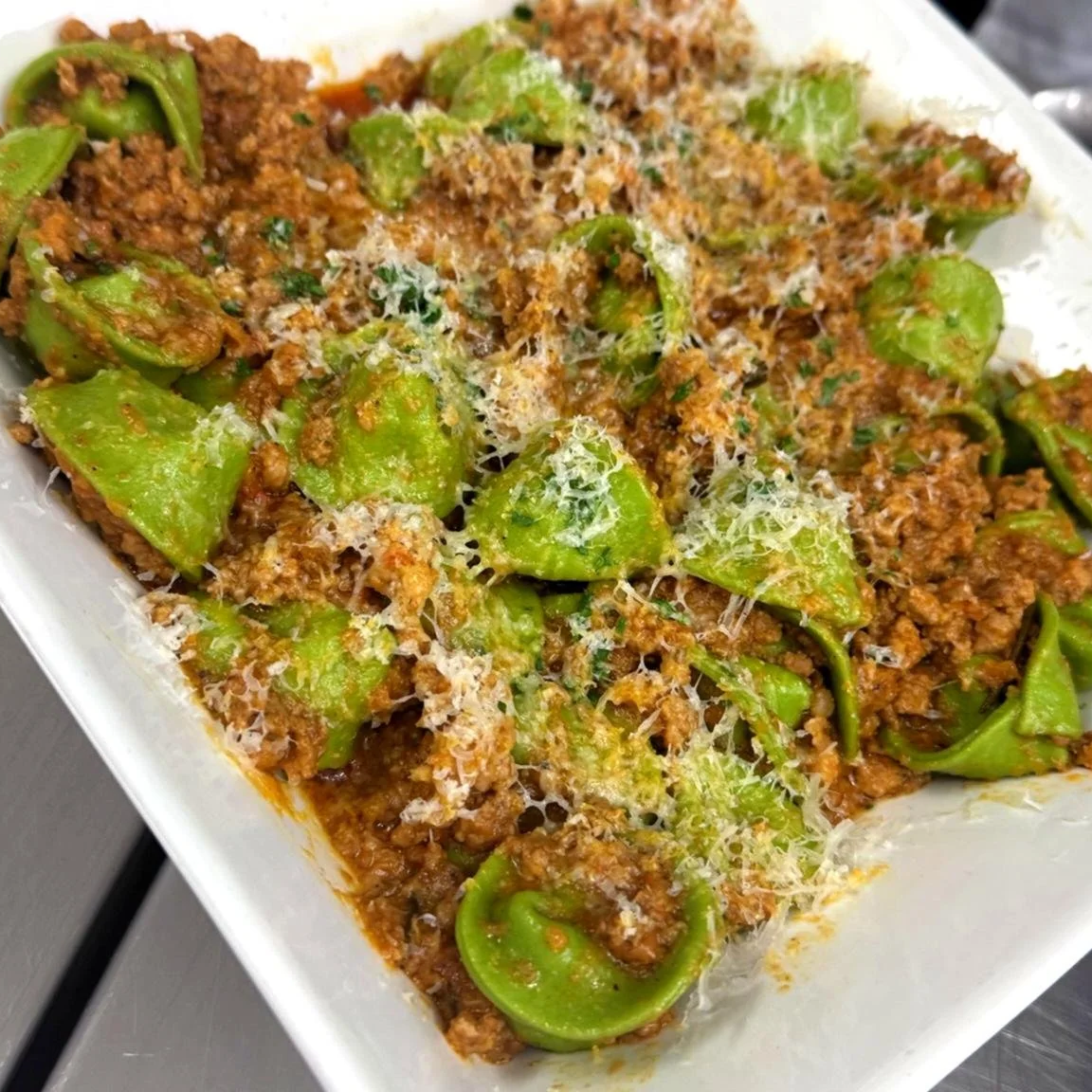 House made spinach tortellini filled with ricotta and finished in a rich Bolognese sauce. 