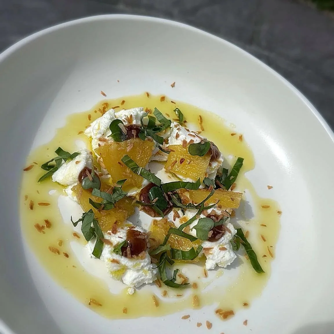 Burrata paired with slow cooked pineapple, basil, mint, toasted coconut and premium olive oil, 