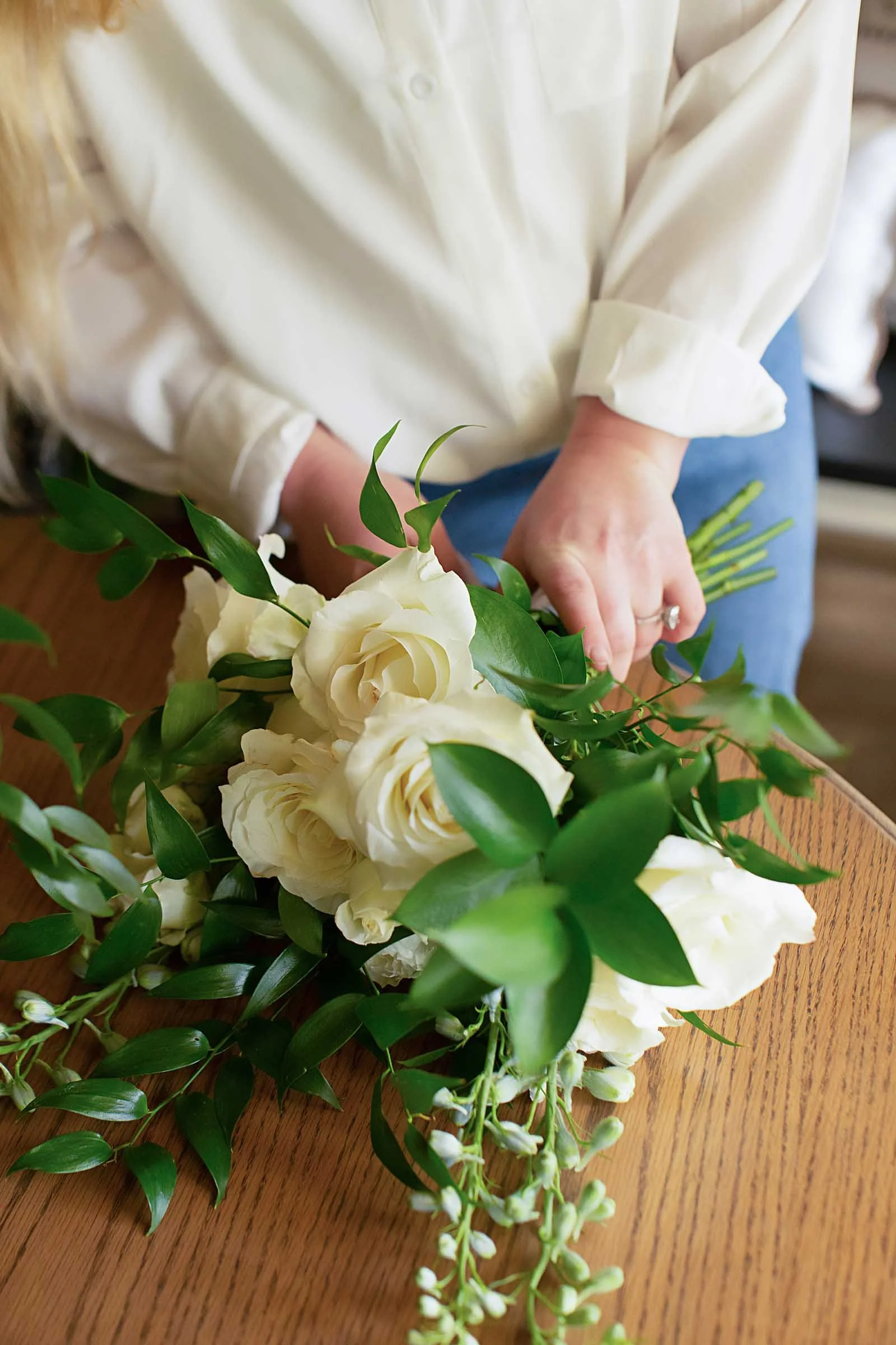 A bouquet of white roses and foliage held by a wedding florist in Central Louisiana.
