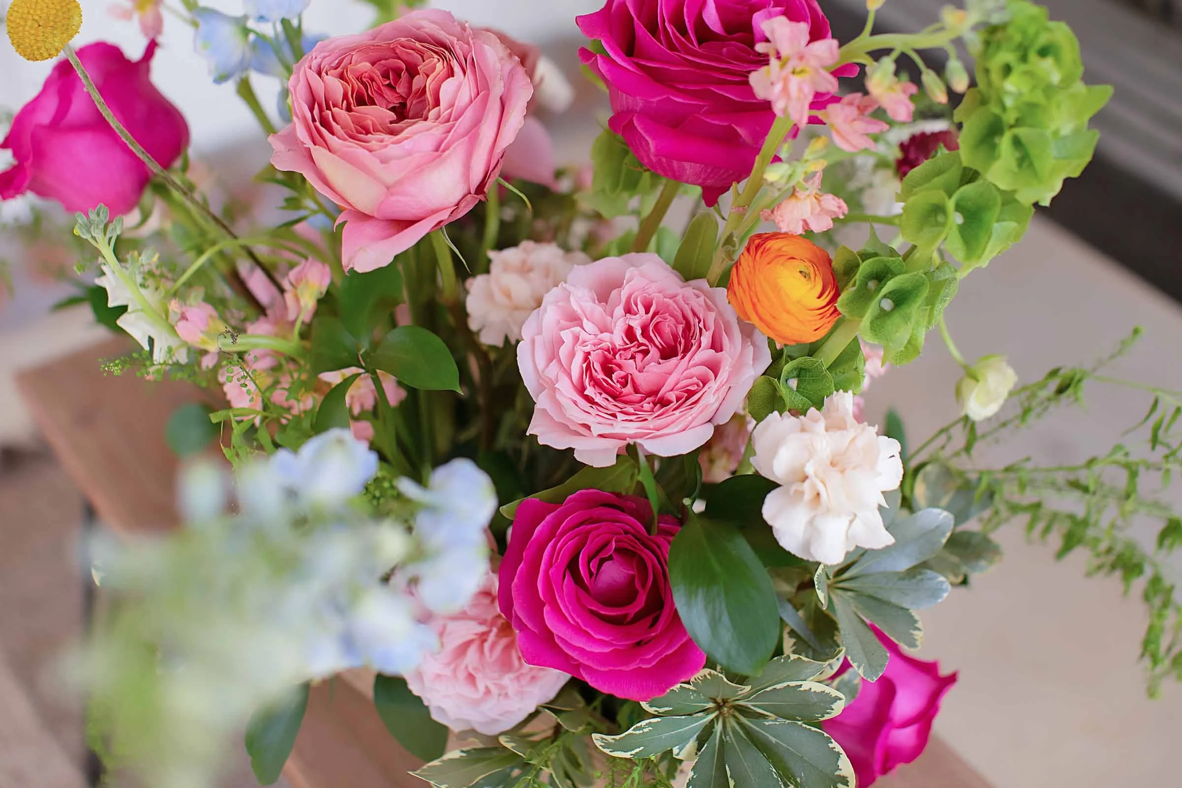 Light and deep pink roses in a bouquet built by a Central Louisiana florist.