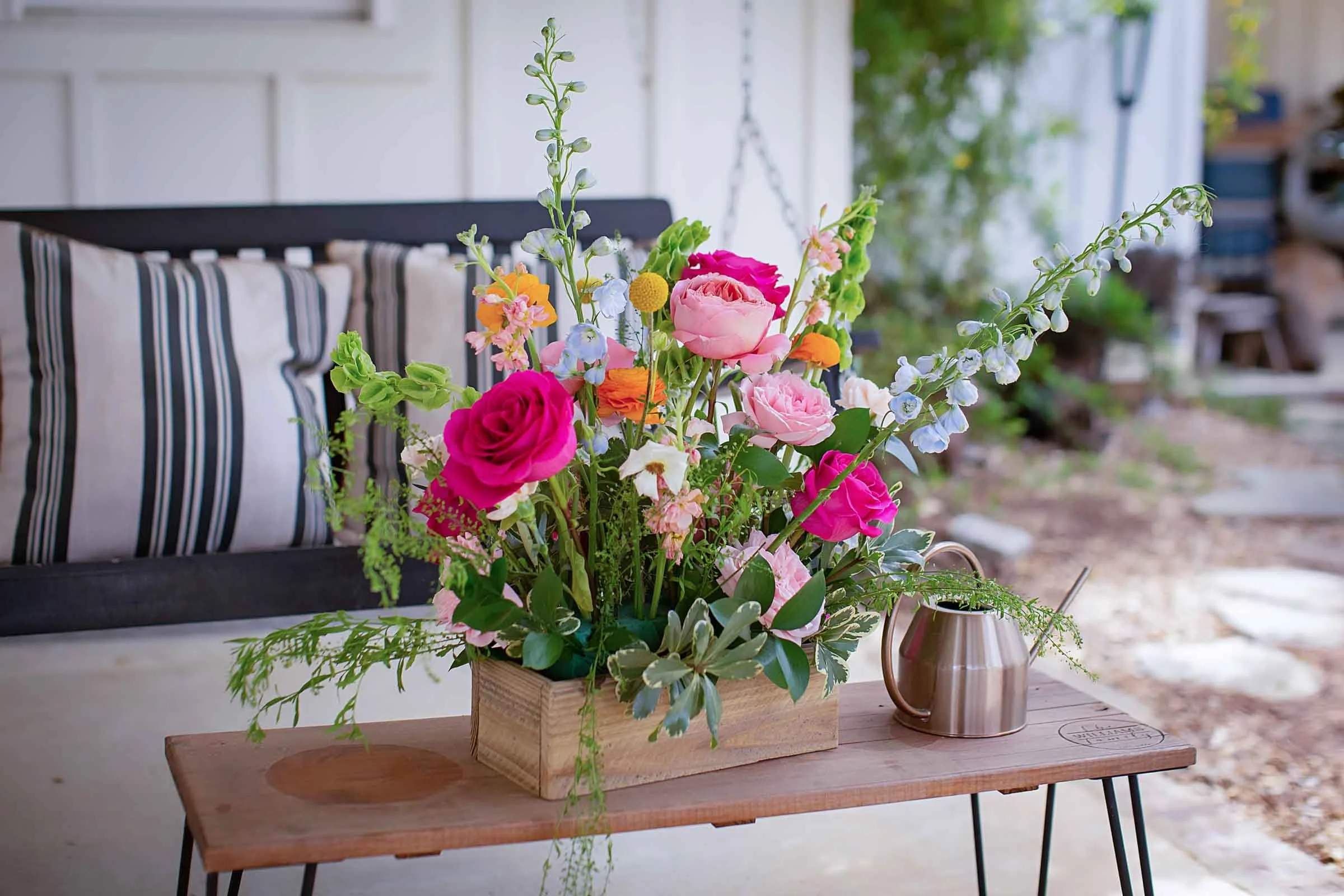 Colorful floral wedding arrangement set on a wooden table in central Louisiana.