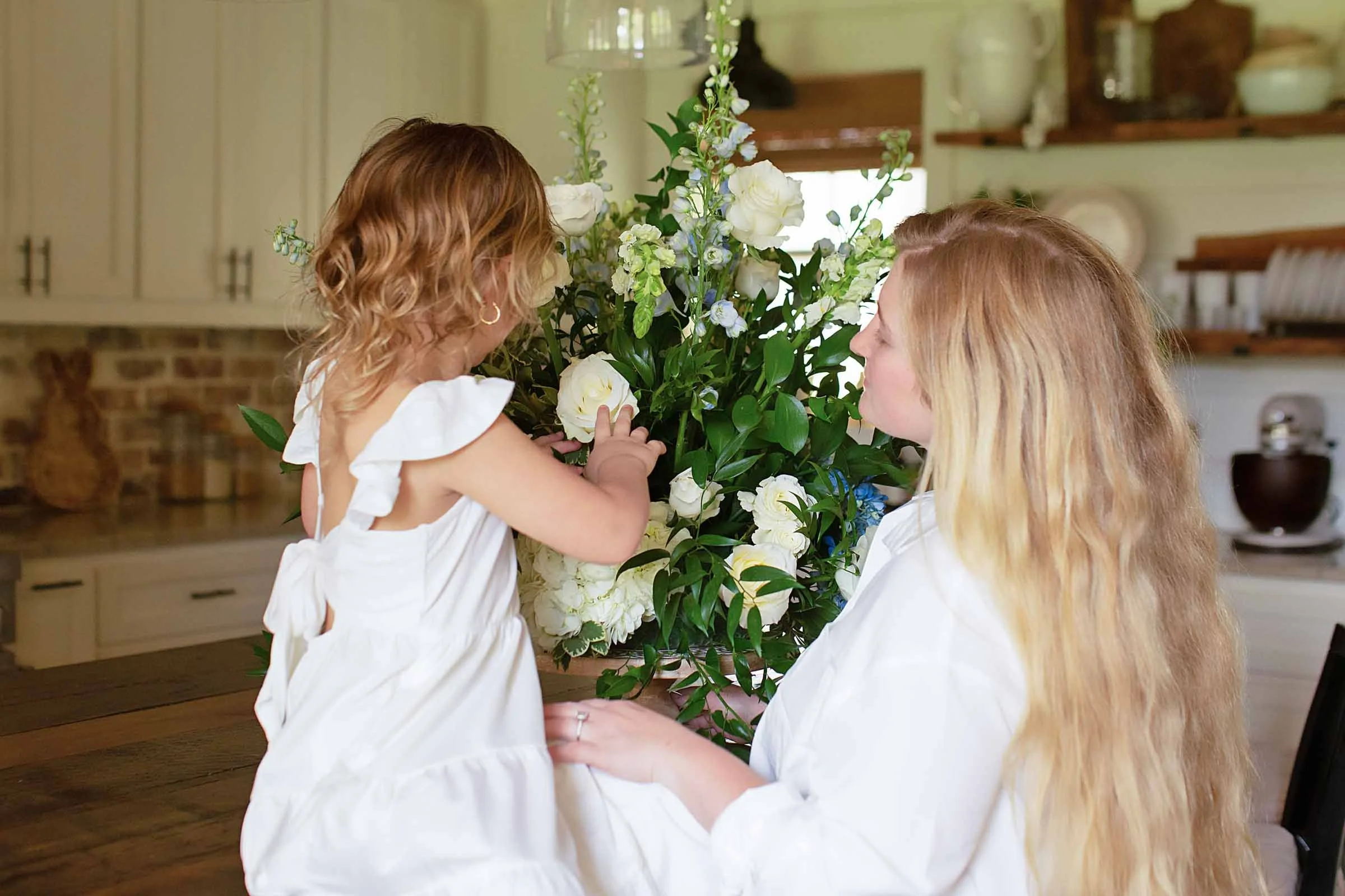 Central Louisiana florist and her daughter arranging flowers.