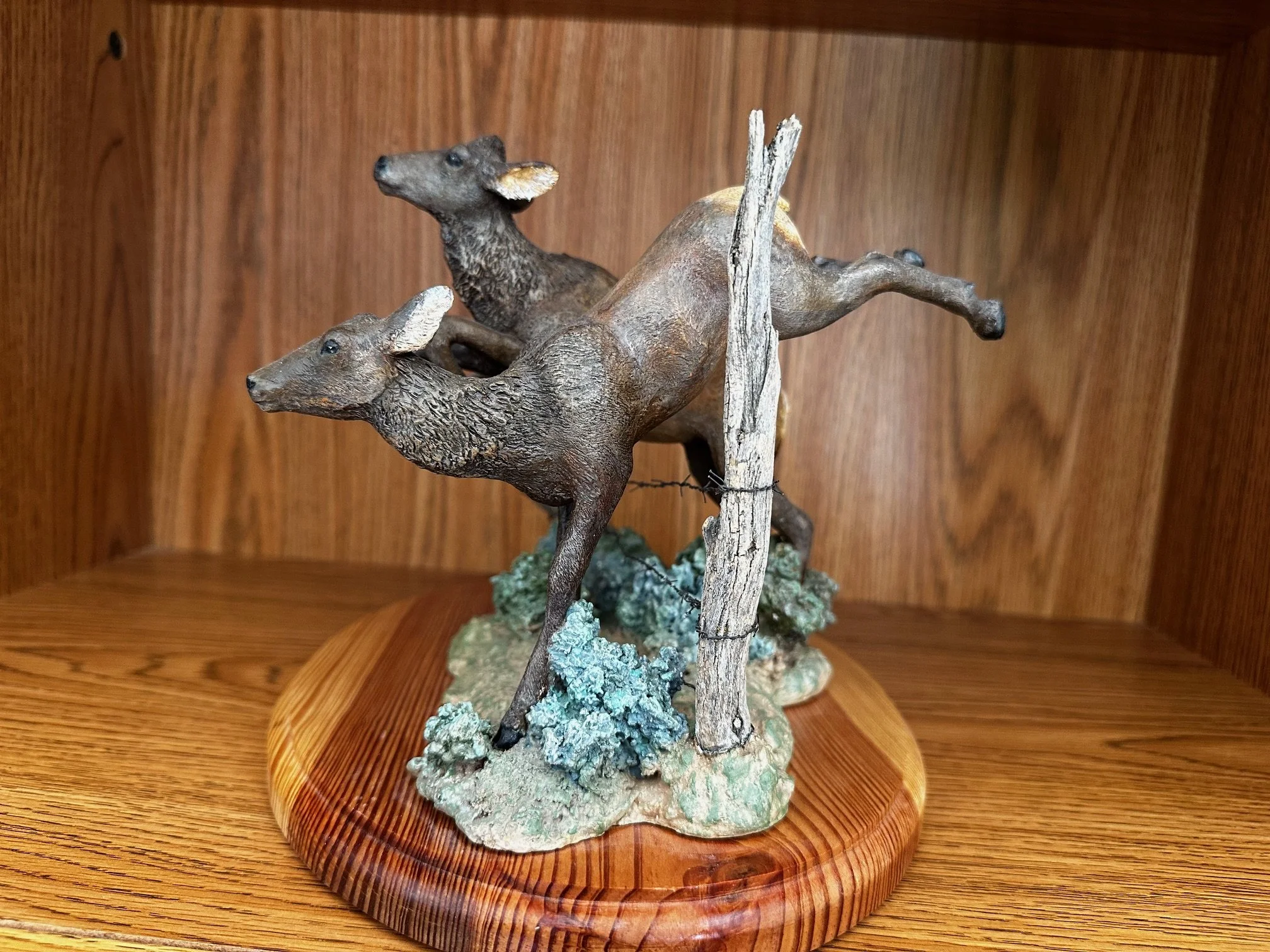 "Cow Elk Jumping Fence"