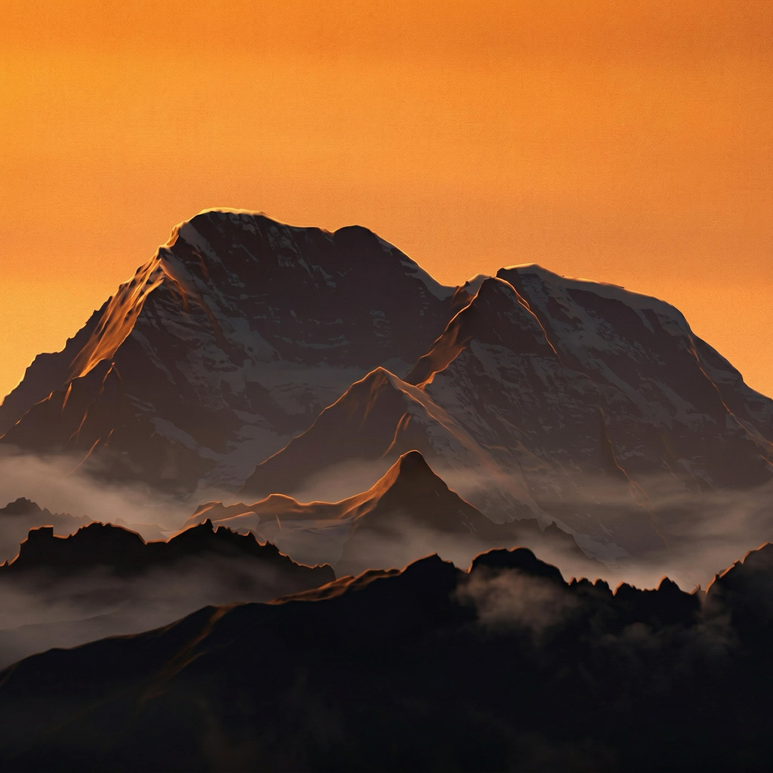 Mountain range with snow-capped peaks during sunset or sunrise with an orange sky.