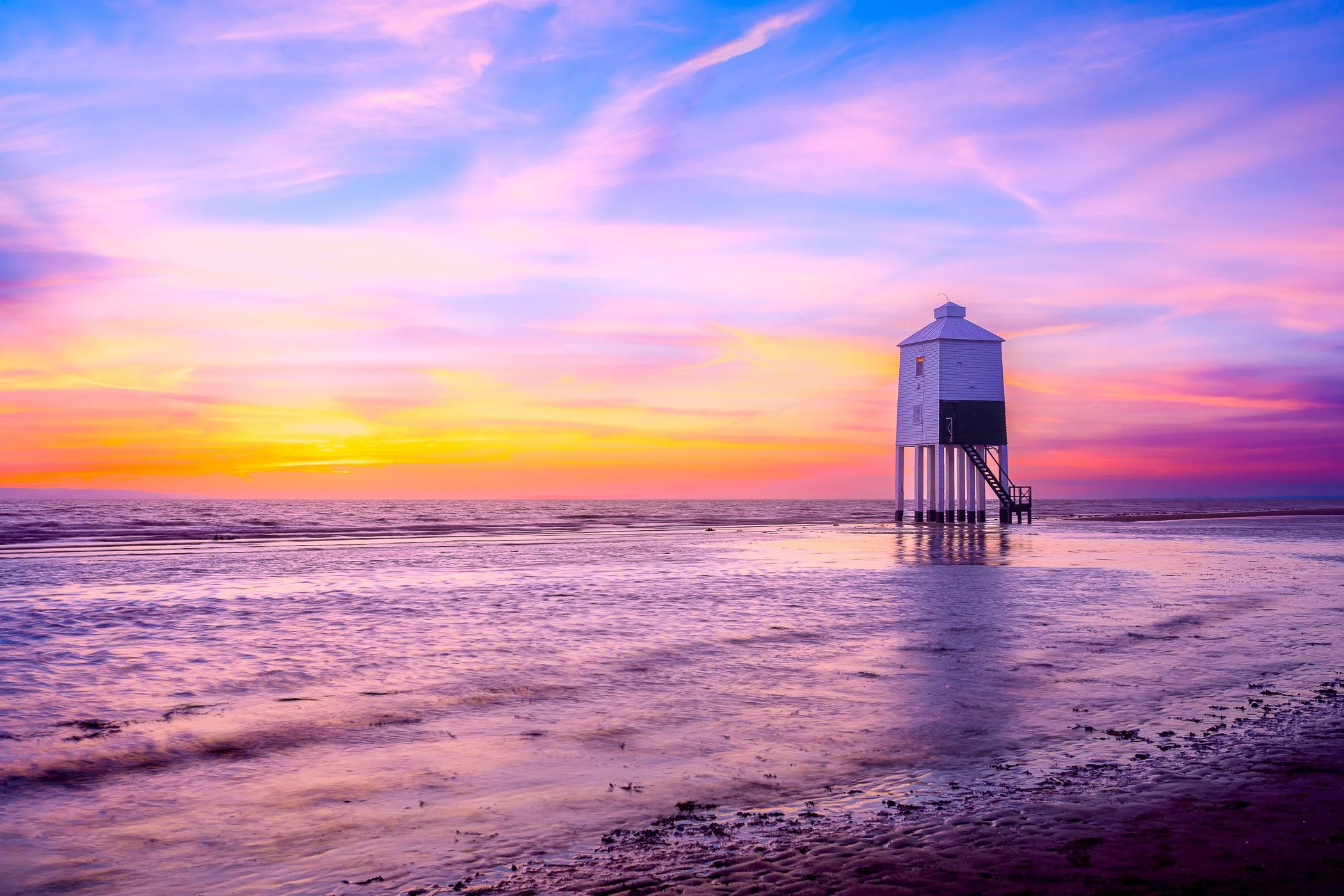 Sunset Radiance A glowing golden-hour composition capturing warm reflections along the damp sands of the shore.