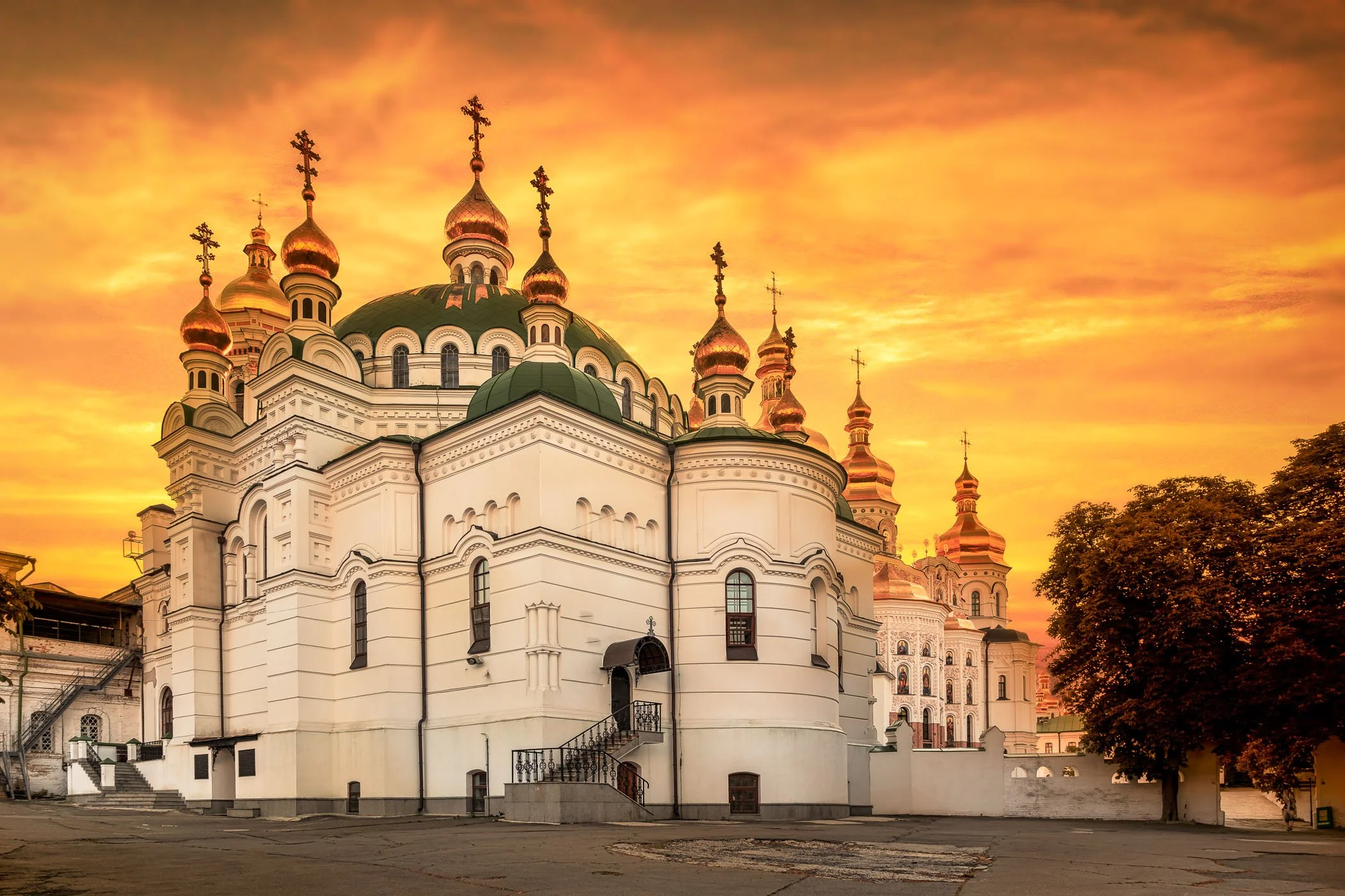 Refectory of Pechersk Lavra at Sunset An atmospheric golden-hour perspective of the ornate Refectory Church within the Kyiv Pechersk Lavra complex.