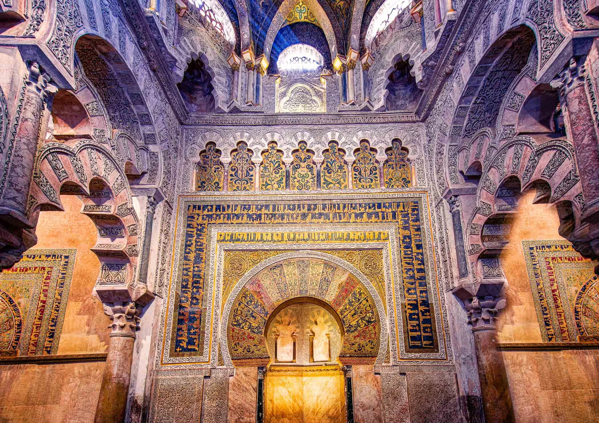 Mihrab of the Mezquita Intricate Moorish archways and gilded mosaic details surrounding the historic prayer niche.