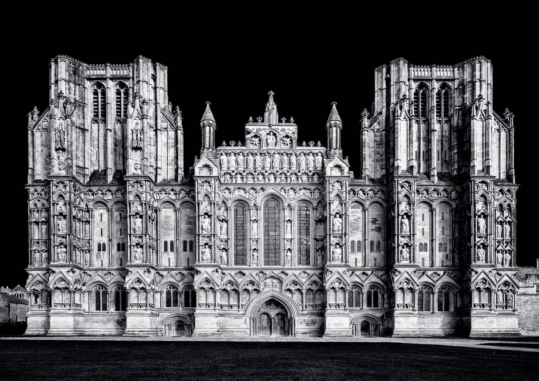 Wells Cathedral Facade Intricate Gothic craftsmanship and stone details highlighted by striking highlights and shadows.