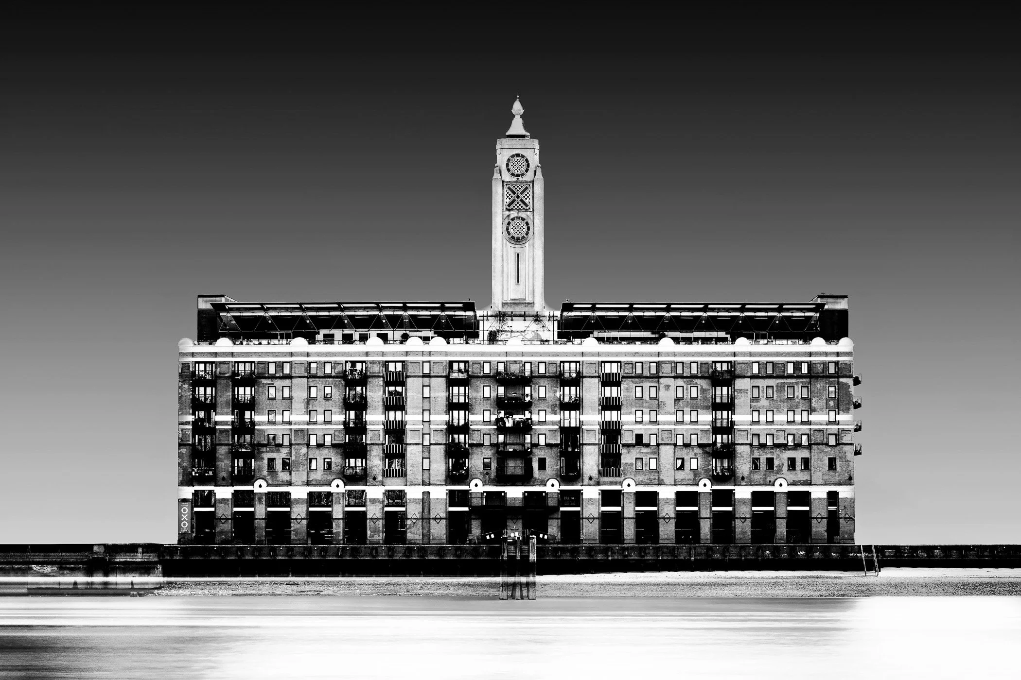 The Oxo Building A bold urban landscape featuring London's iconic riverside landmark set against a dramatic sky.