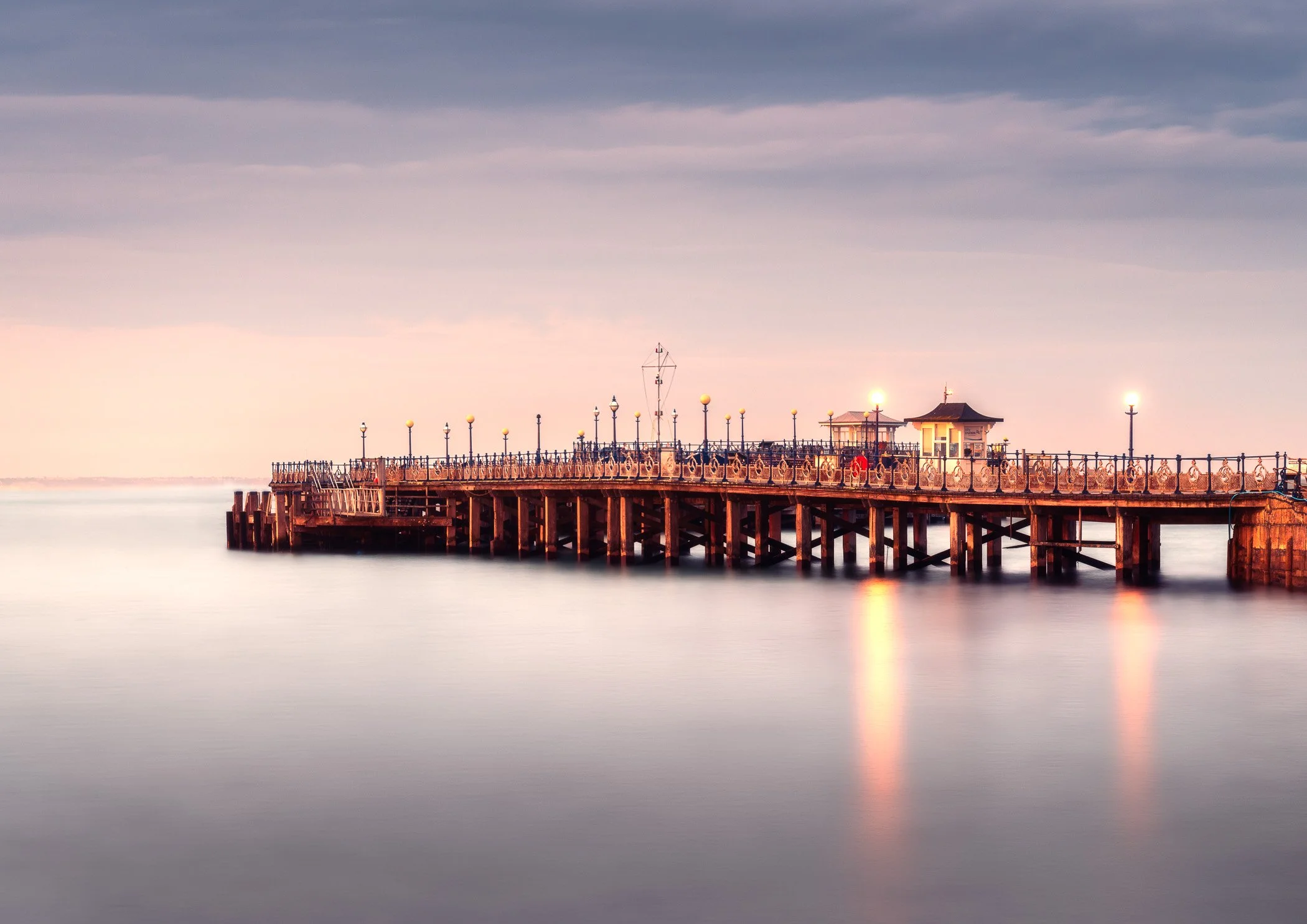 The Glow Before Nightfall A warm long-exposure landscape capturing the final radiant light fading across the horizon.