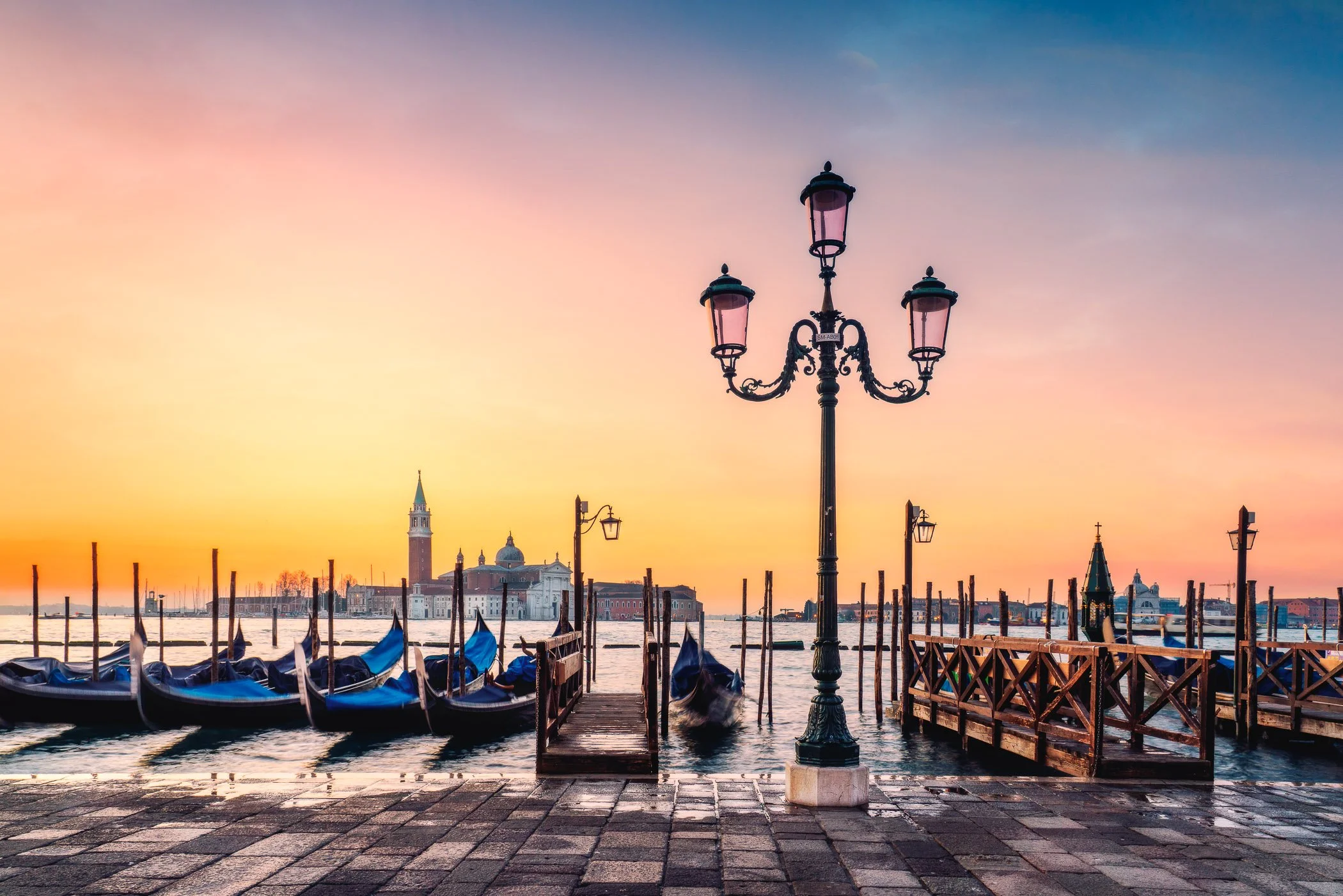 San Giorgio Maggiore & Gondolas Iconic gondola bows pointing toward the majestic island church across the bay.